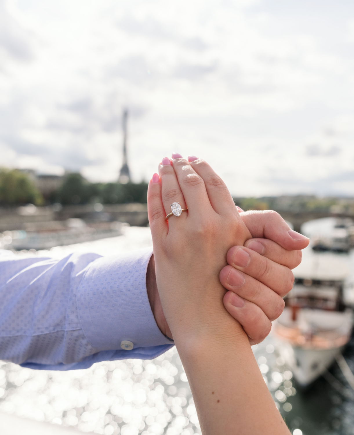 woman shows her engagement ring in paris