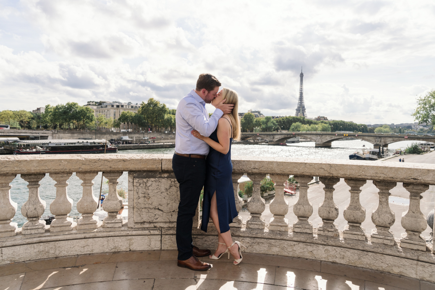 newly engaged couple kiss passionately with view of the eiffel tower in paris