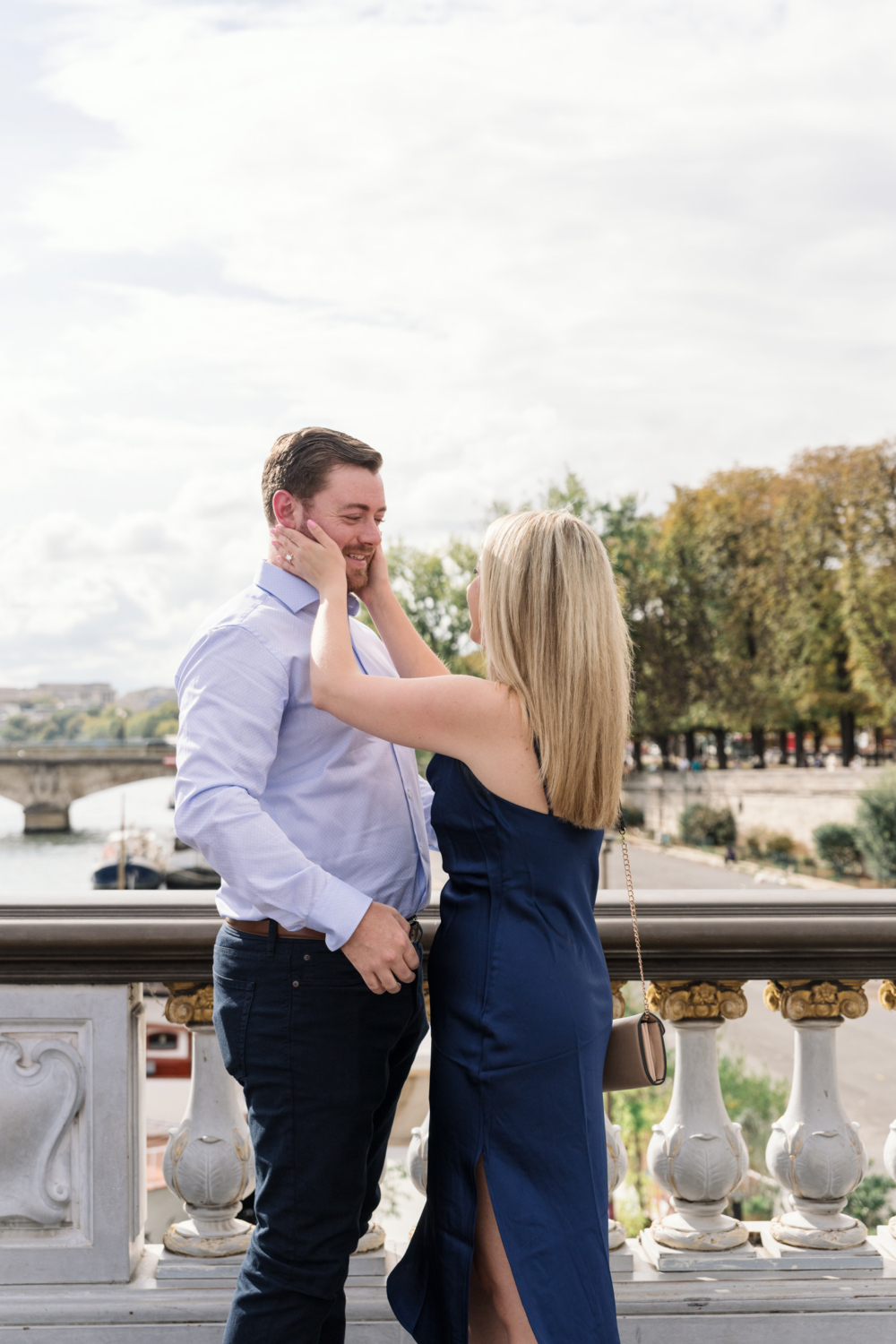 newly engaged couple gaze at each other on pont alexandre in paris