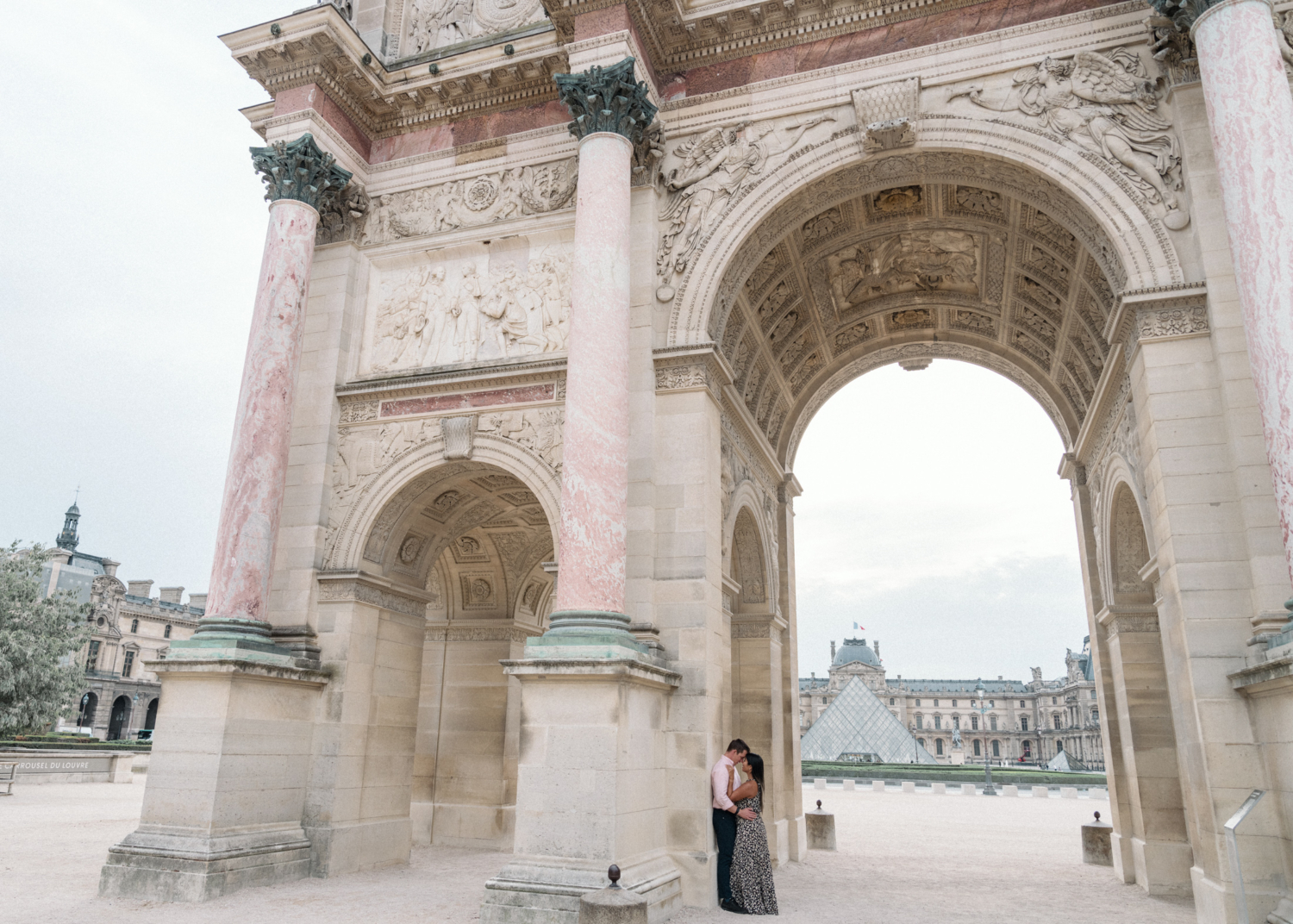 newly engaged couple pose at arc du carrousel in paris france