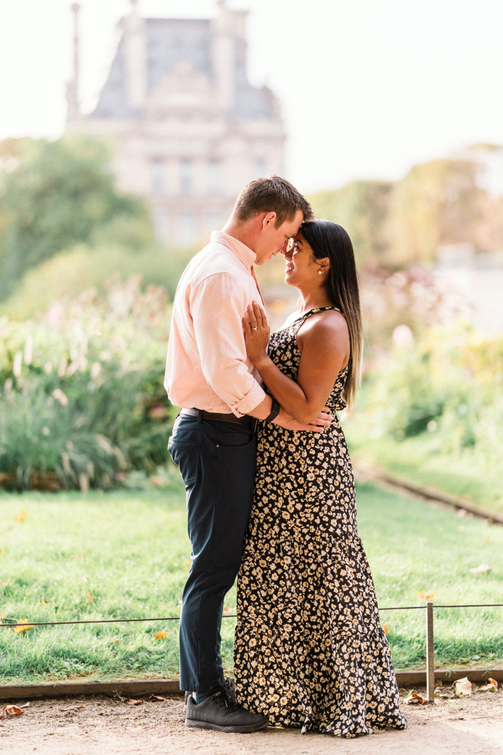 newly engaged couple embrace in the tuileries gardens in paris france