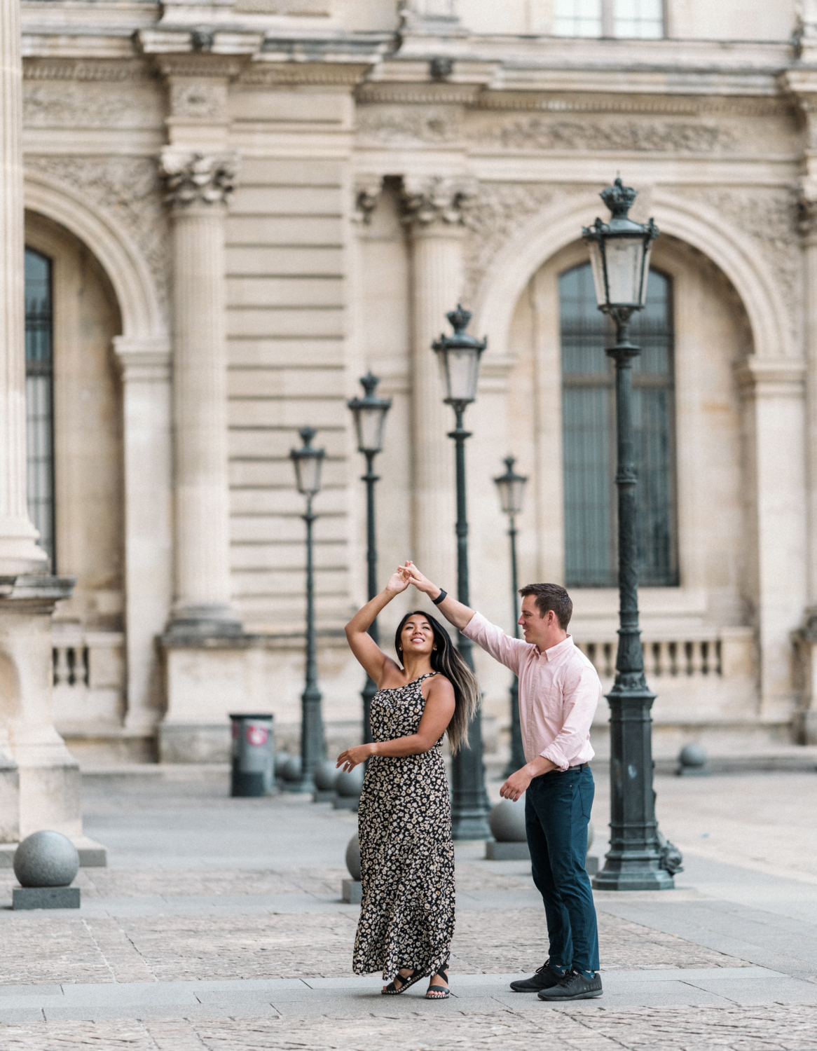 newly engaged couple dance at the louvre museum in paris france