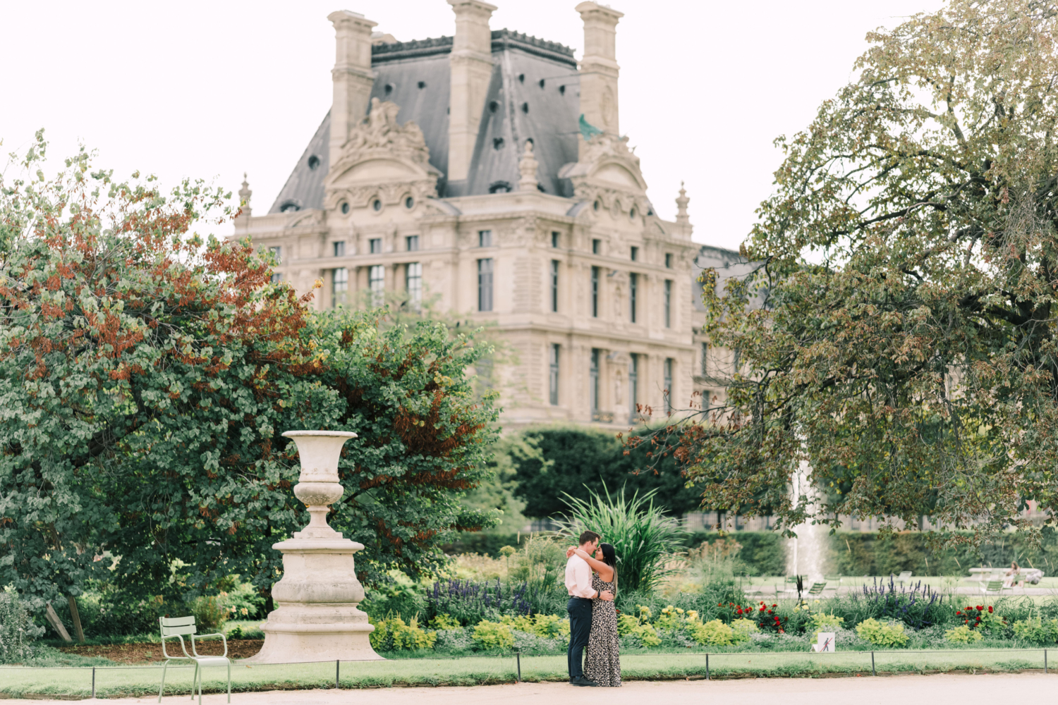 newly engaged couple hug in the tuileries gardens in paris france