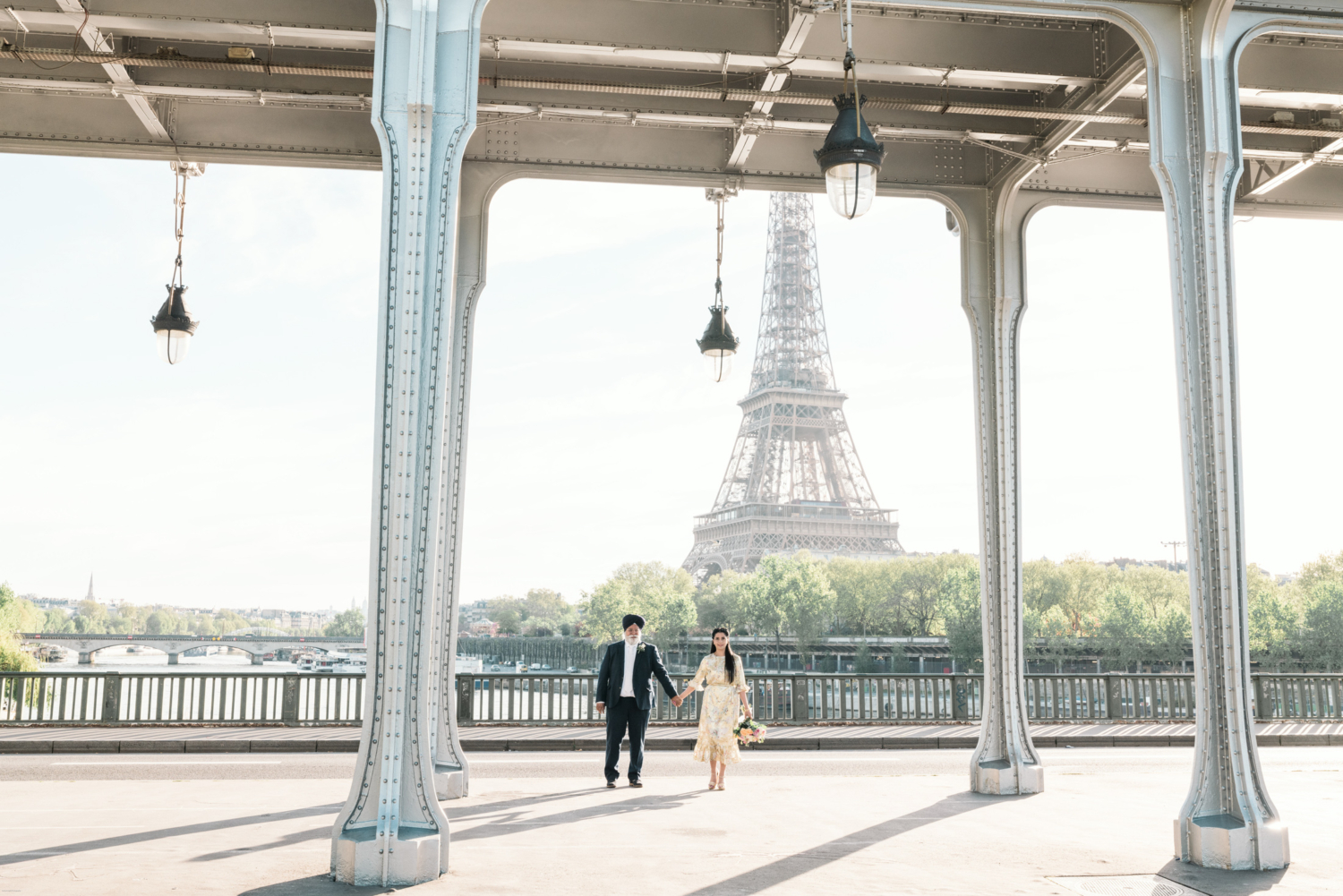 mature indian couple pose for photoshoot with eiffel tower and bridge in paris