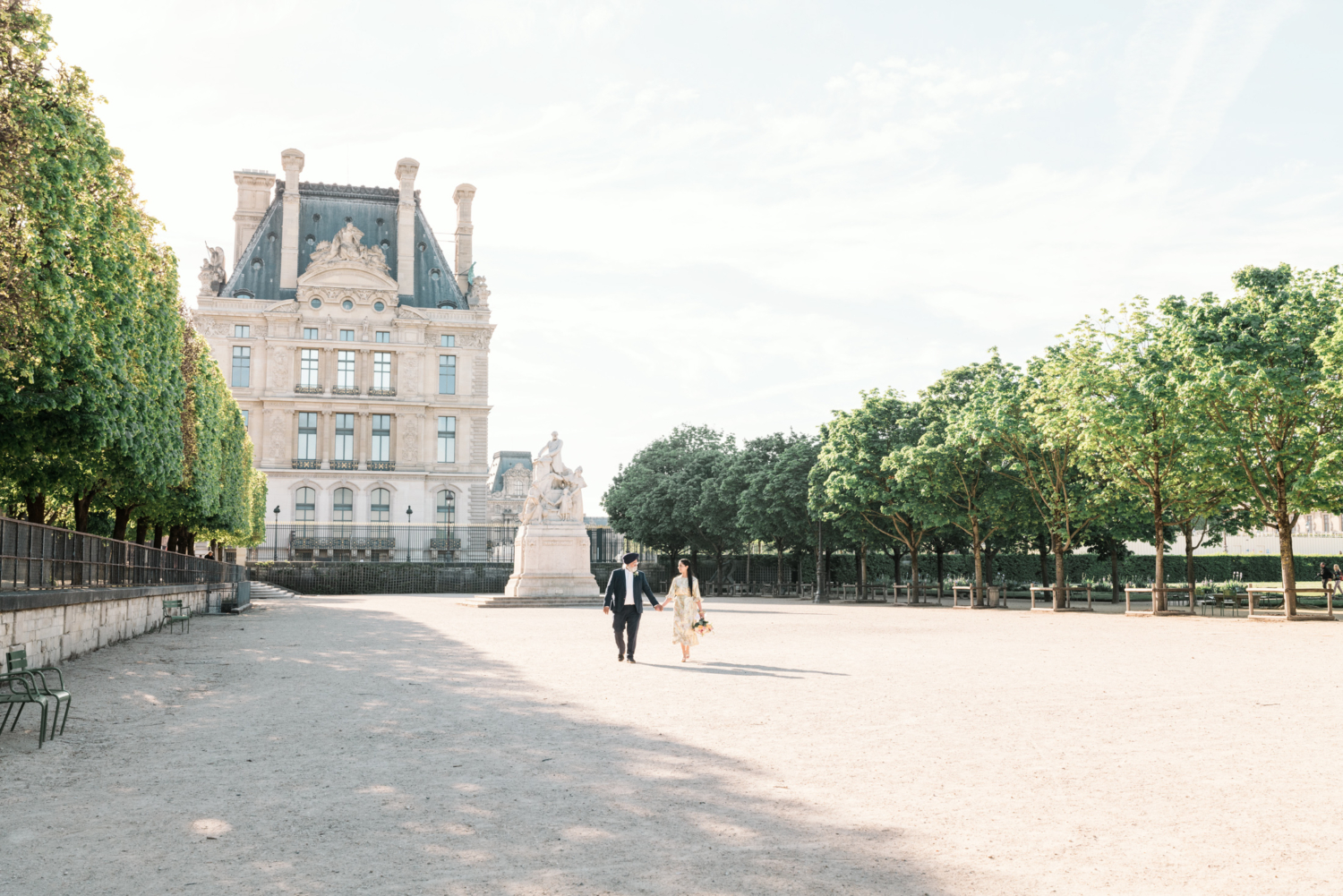 mature indian couple walk hand in hand in garden near the louvre in paris