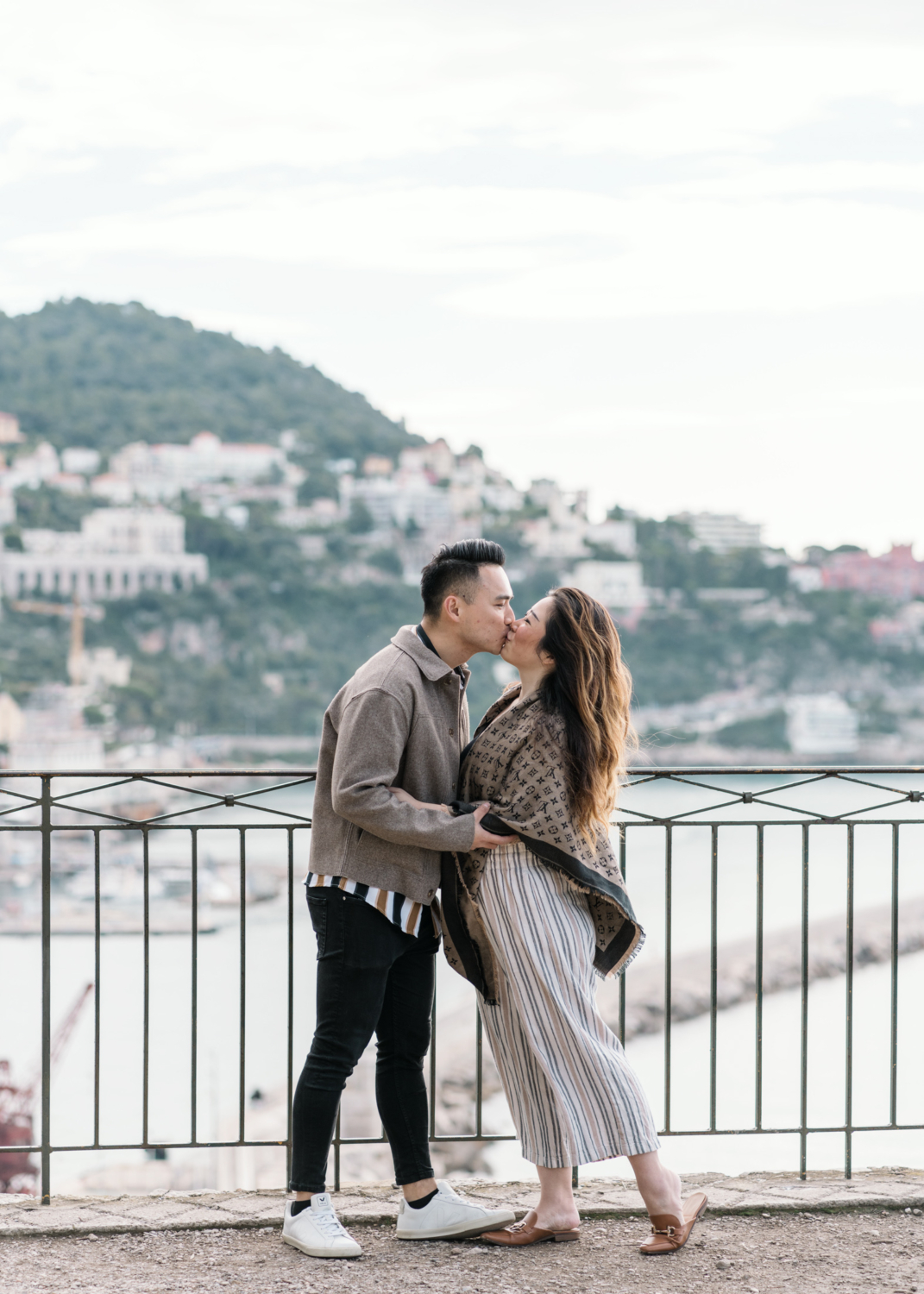 newly engaged couple kiss with view of mont boron in nice, france