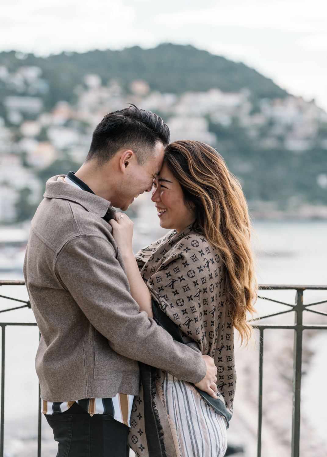 newly engaged couple smile broadly at each other in nice, france