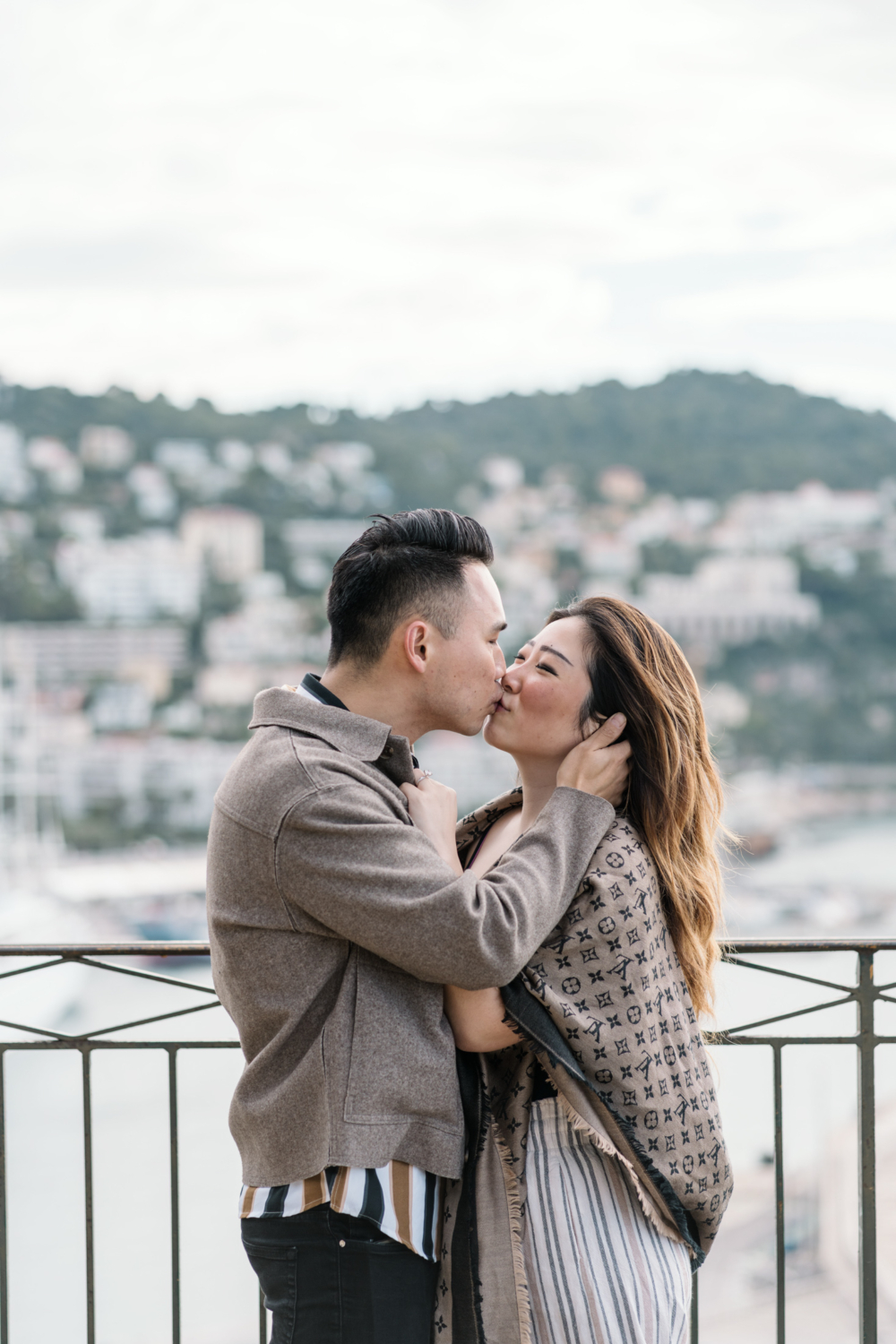 man kisses his new fiancee in nice, france