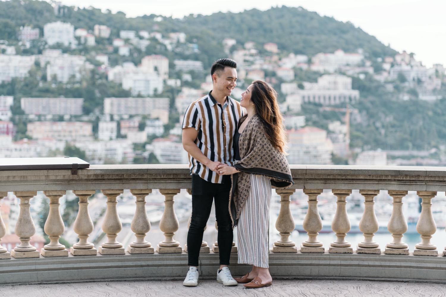 cute newly engaged couple pose with view of mont boron in nice, france