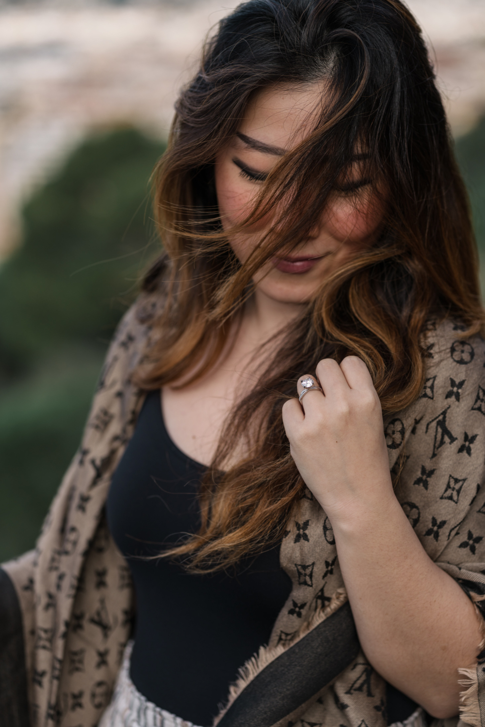 newly engaged woman admires her engagement ring in nice, france