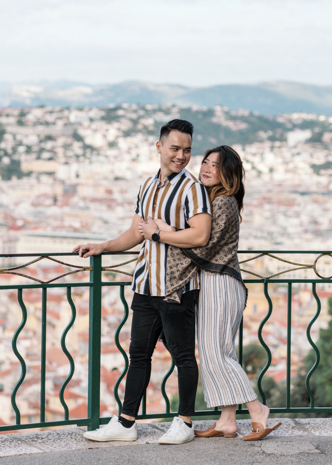 woman embraces man after their engagement in nice, france