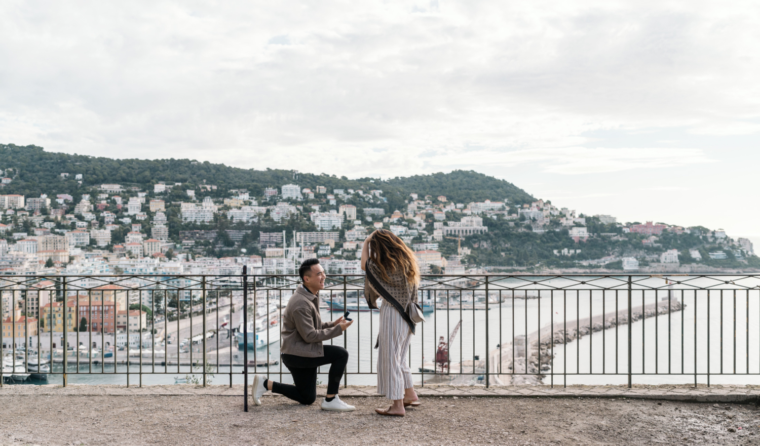 man on one knee presents ring to woman in nice france