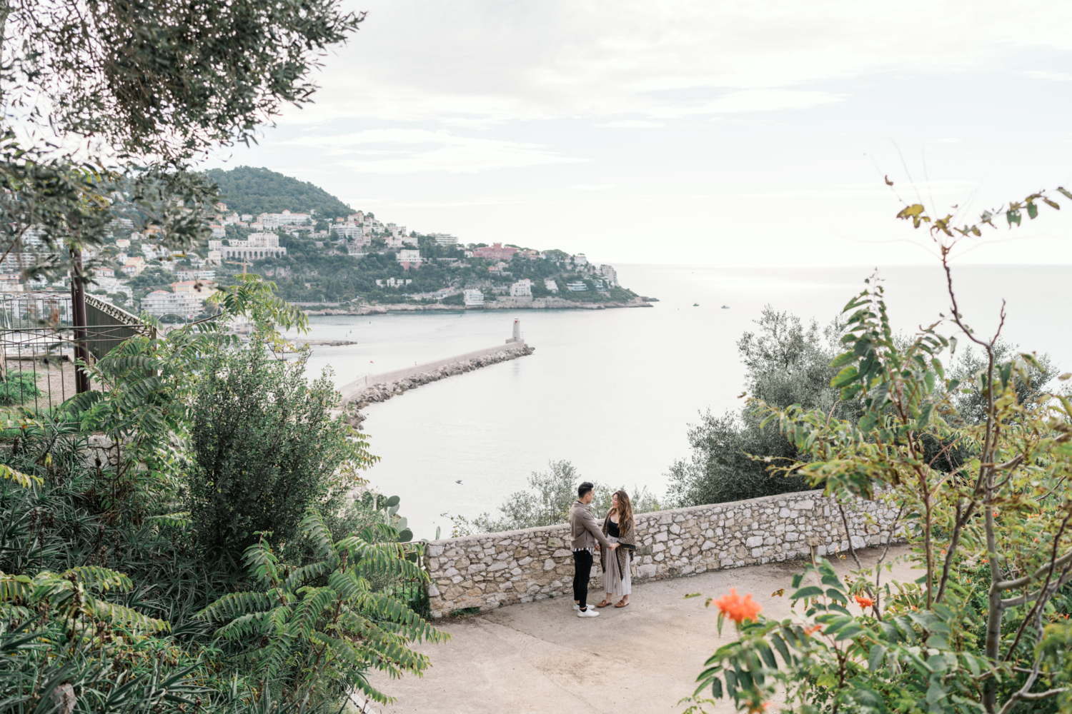 newly engaged couple hold hands with view of sea in nice france