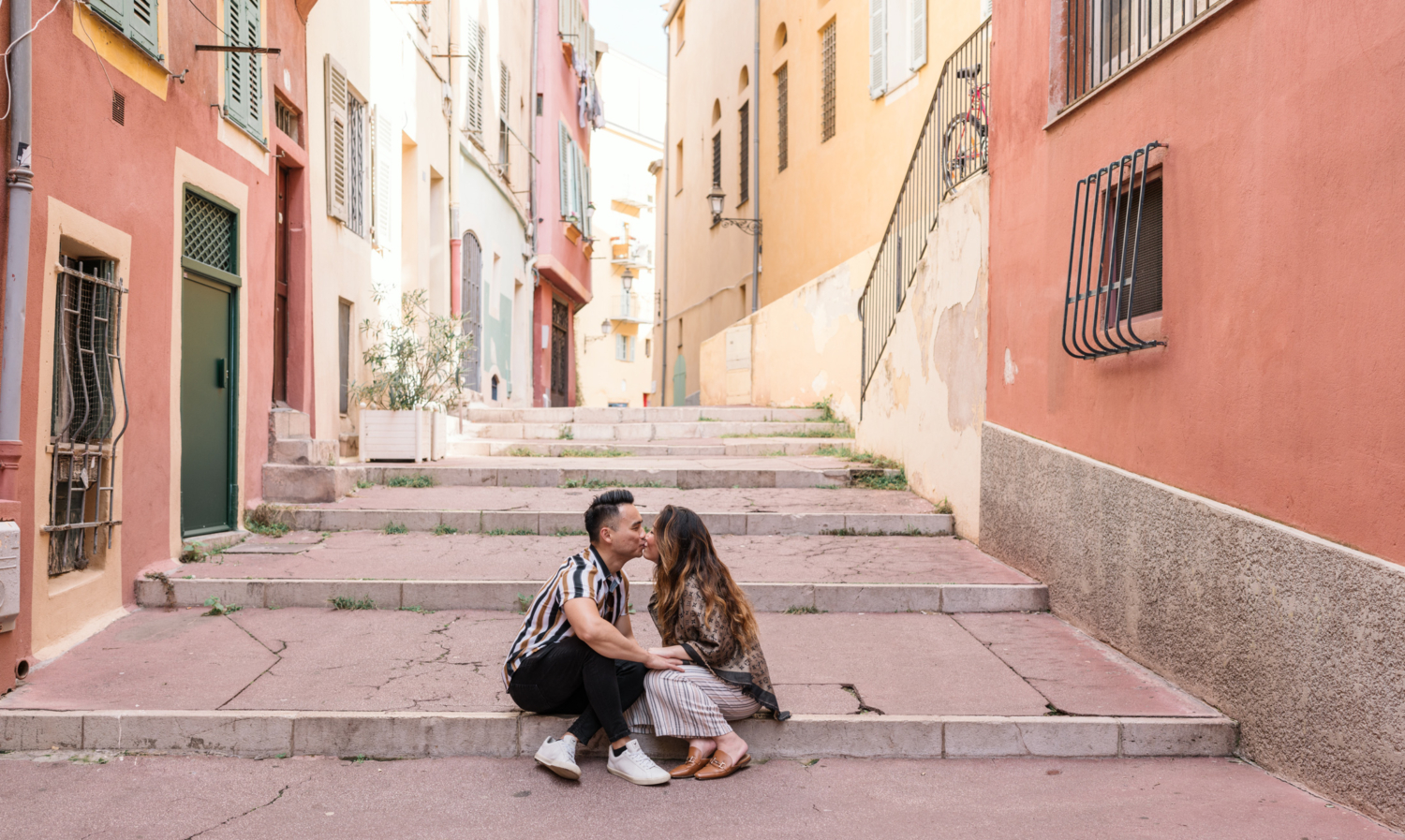 newly engaged couple kiss in old town nice france