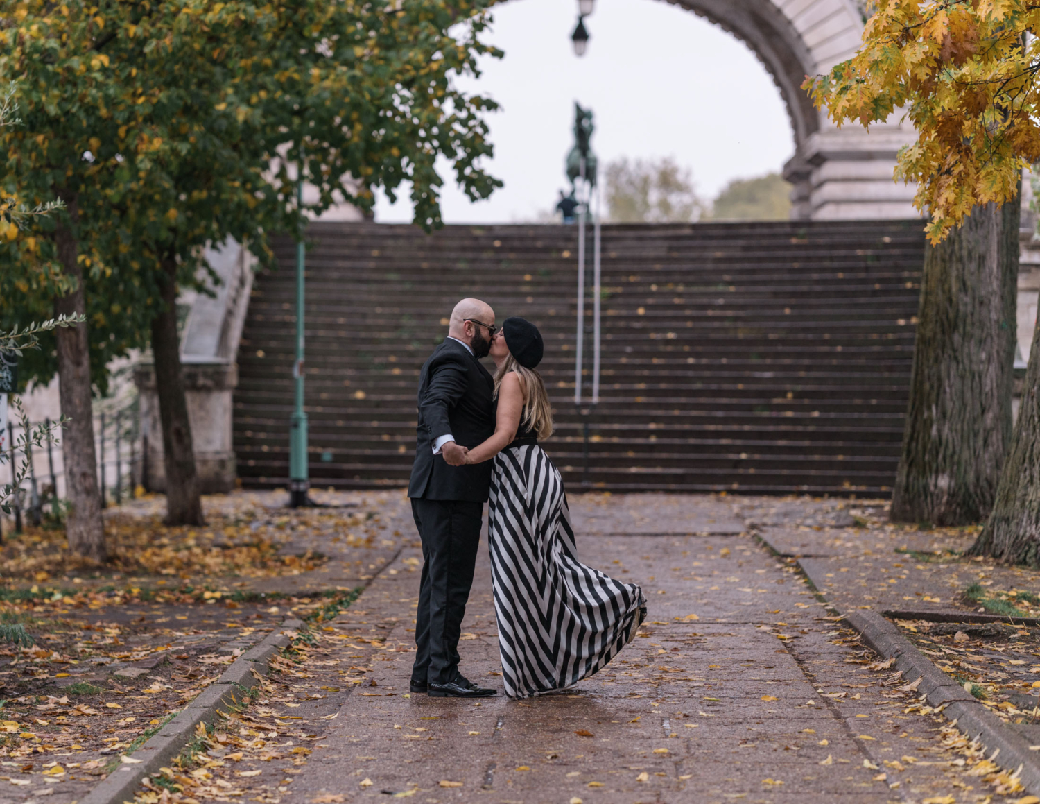 charming married kiss passionately in paris in the autumn