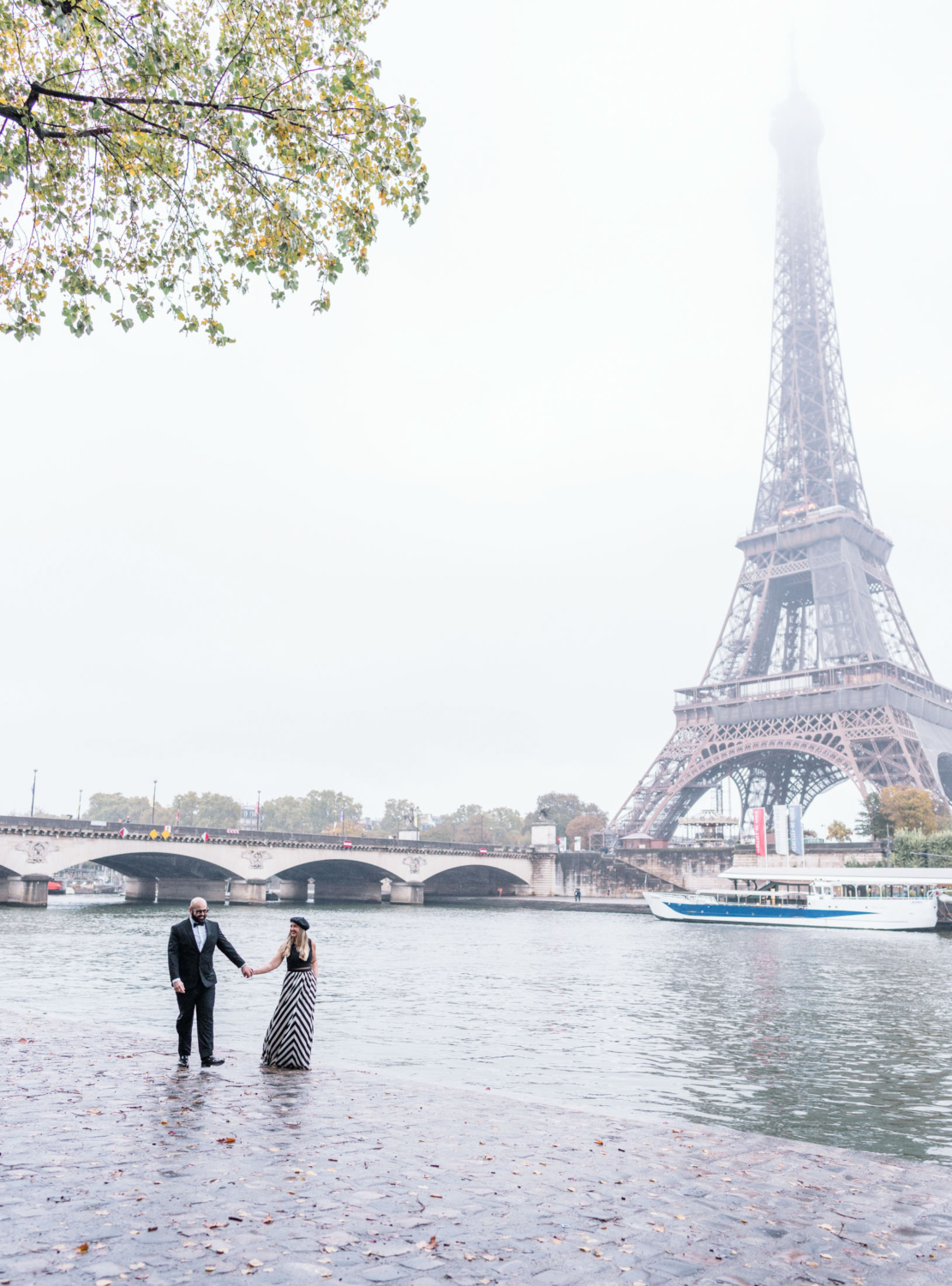 cute mature couple walk holding hands near the eiffel tower paris