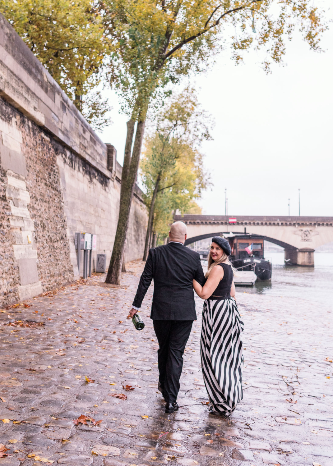 cute lady looks at camera walking in the rain in paris france