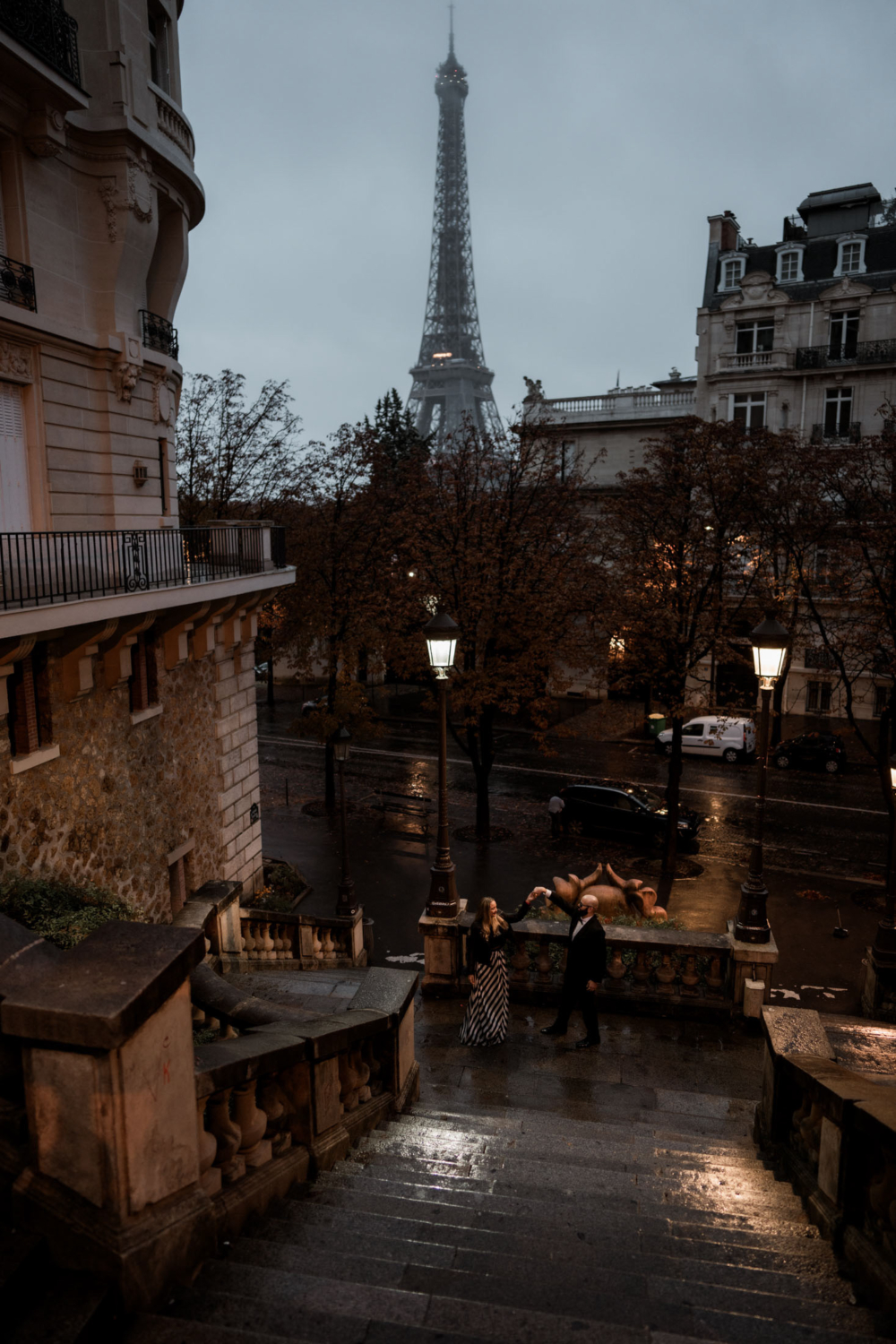 married couple pose with view of the eiffel tower in paris