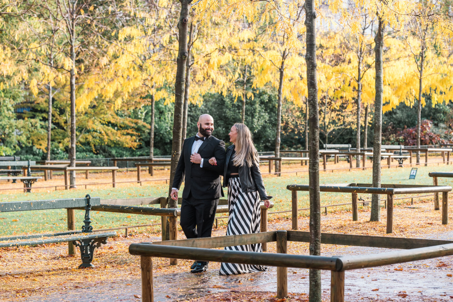 cute mature couple laugh walking in luxembourg gardens in autumn in paris