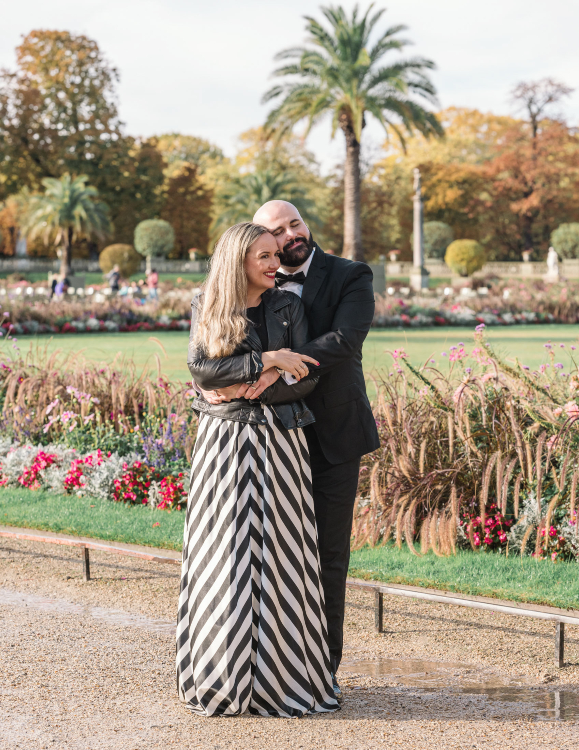 charming mature couple embrace in luxembourg gardens in paris