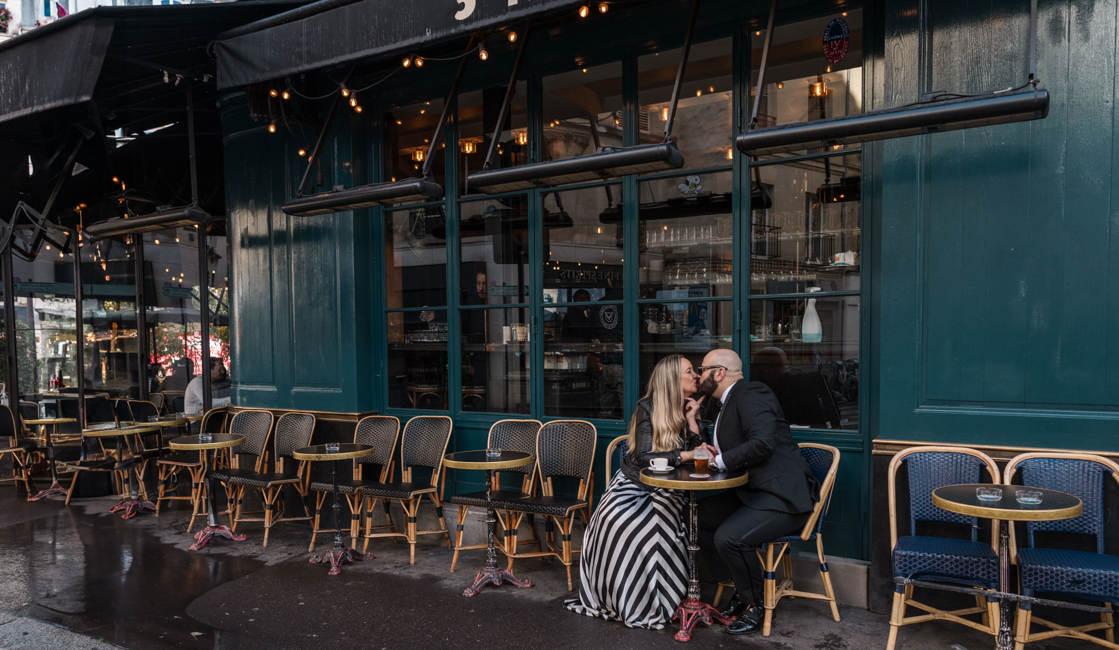 cute mature couple kiss at paris cafe