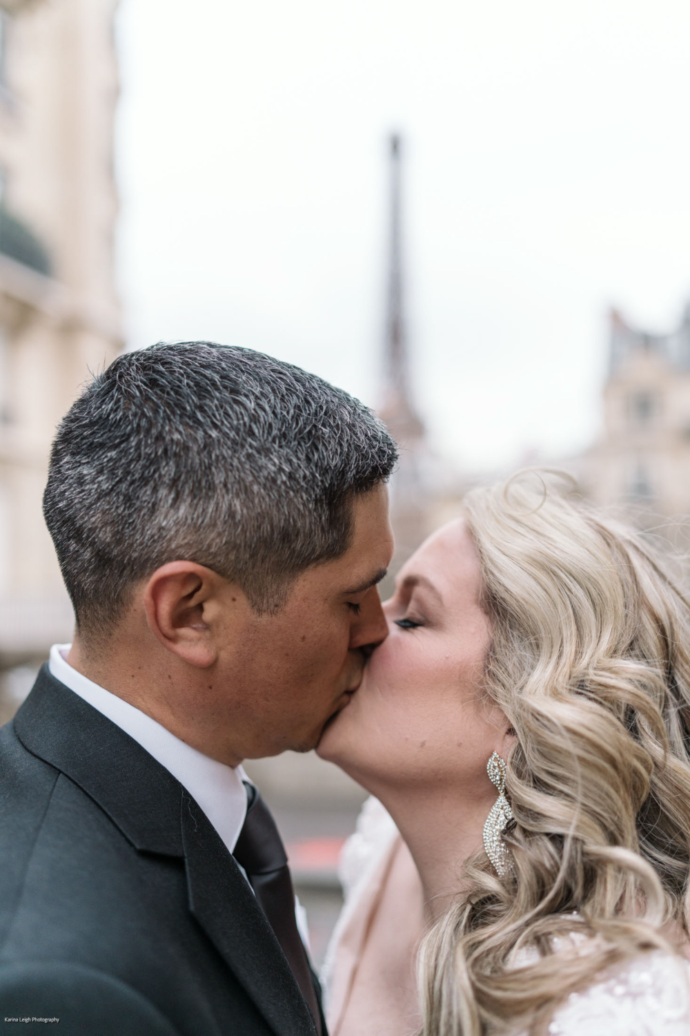 tender kiss of bride and groom in paris france