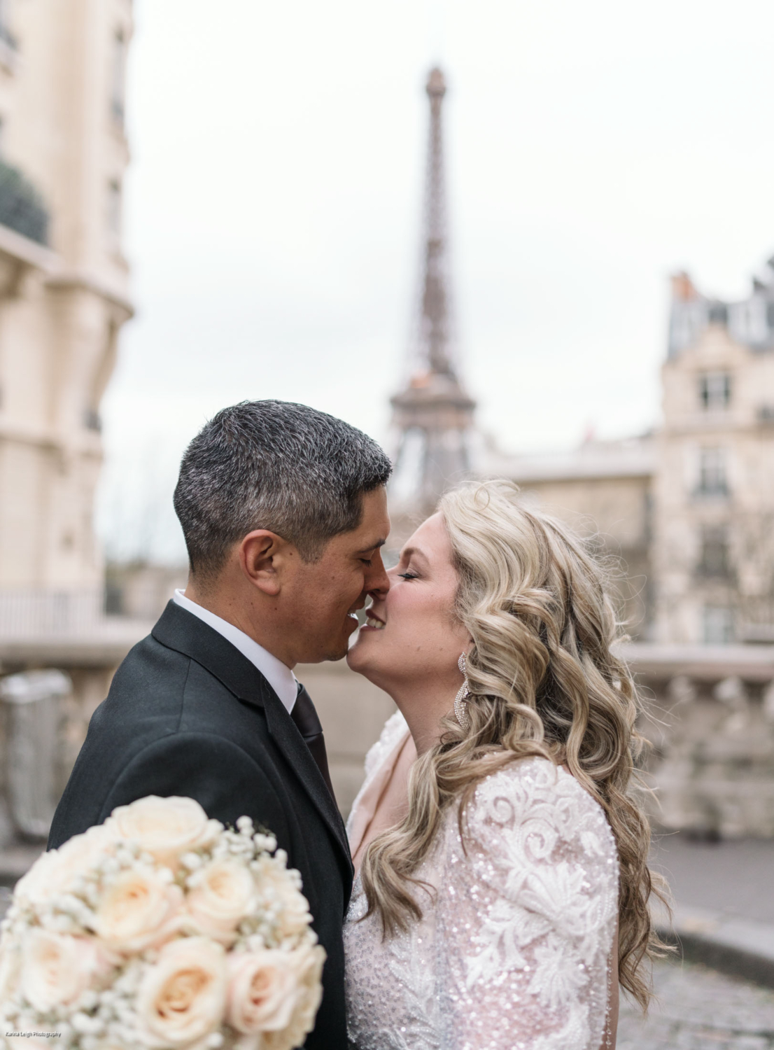 passionate kiss between bride and groom in paris with eiffel tower backdrop