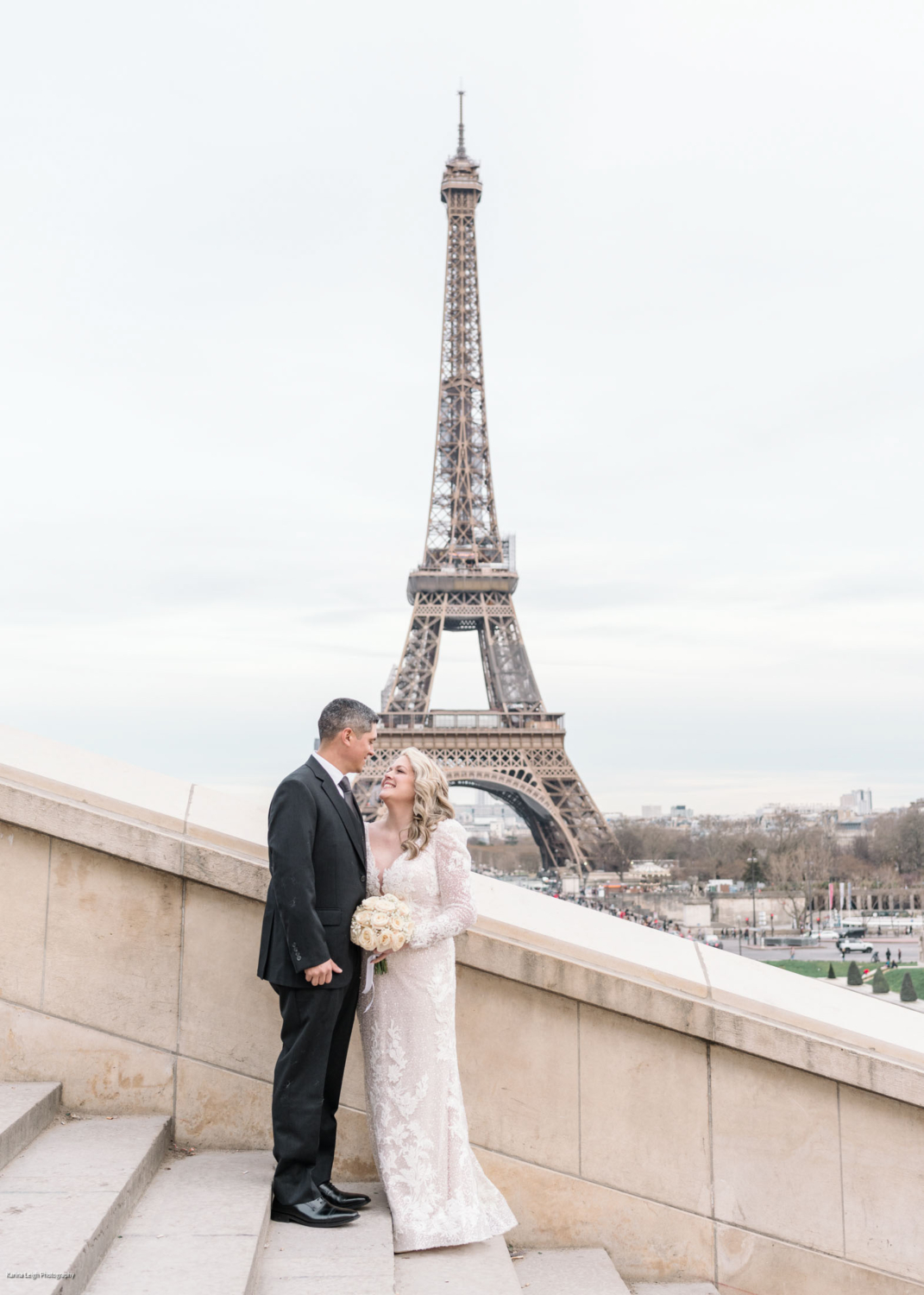 mature couple wedding photoshoot in paris with view of eiffel tower on staircase