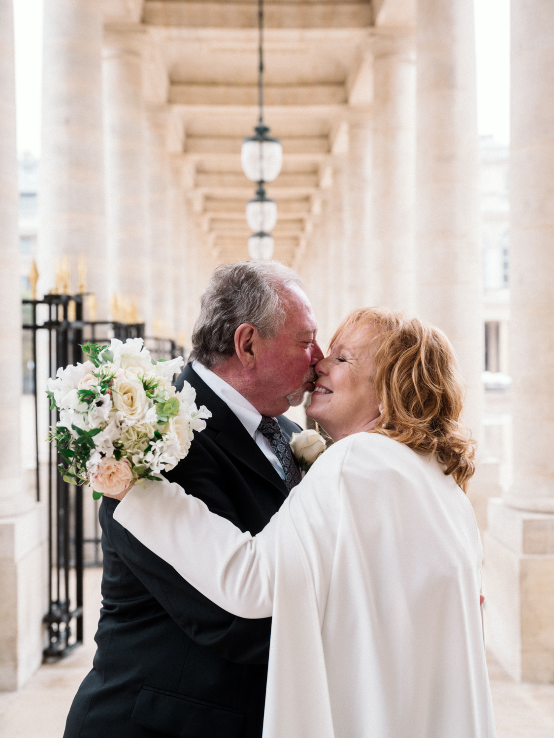 mature newlywed couple kiss and hug after their wedding in paris france