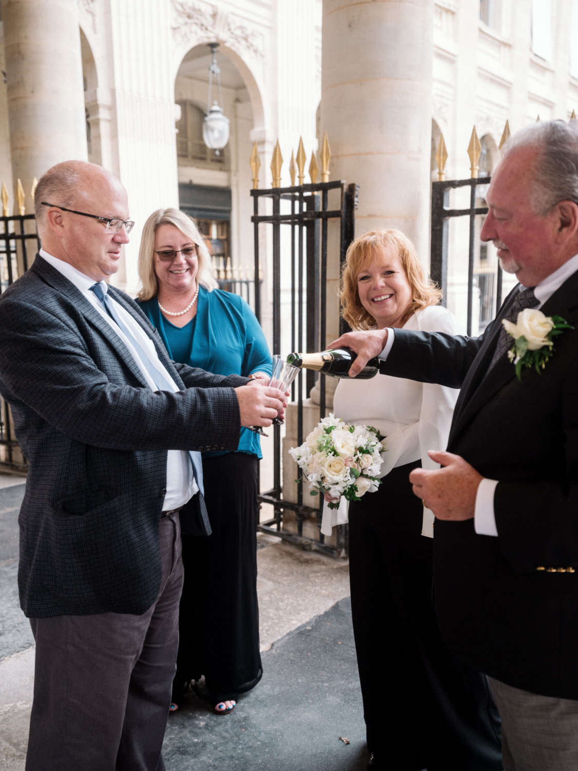 newlyweds celebrate wedding in paris with friends and champagne