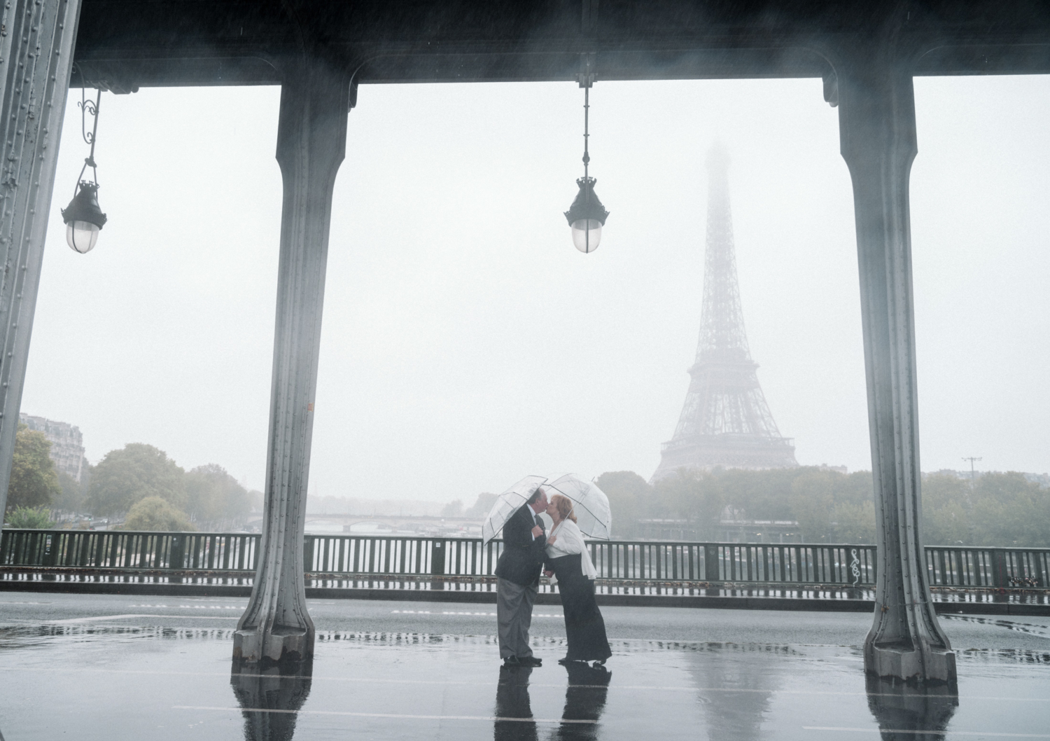 rainy wedding photoshoot for mature couple in paris france with view of eiffel tower