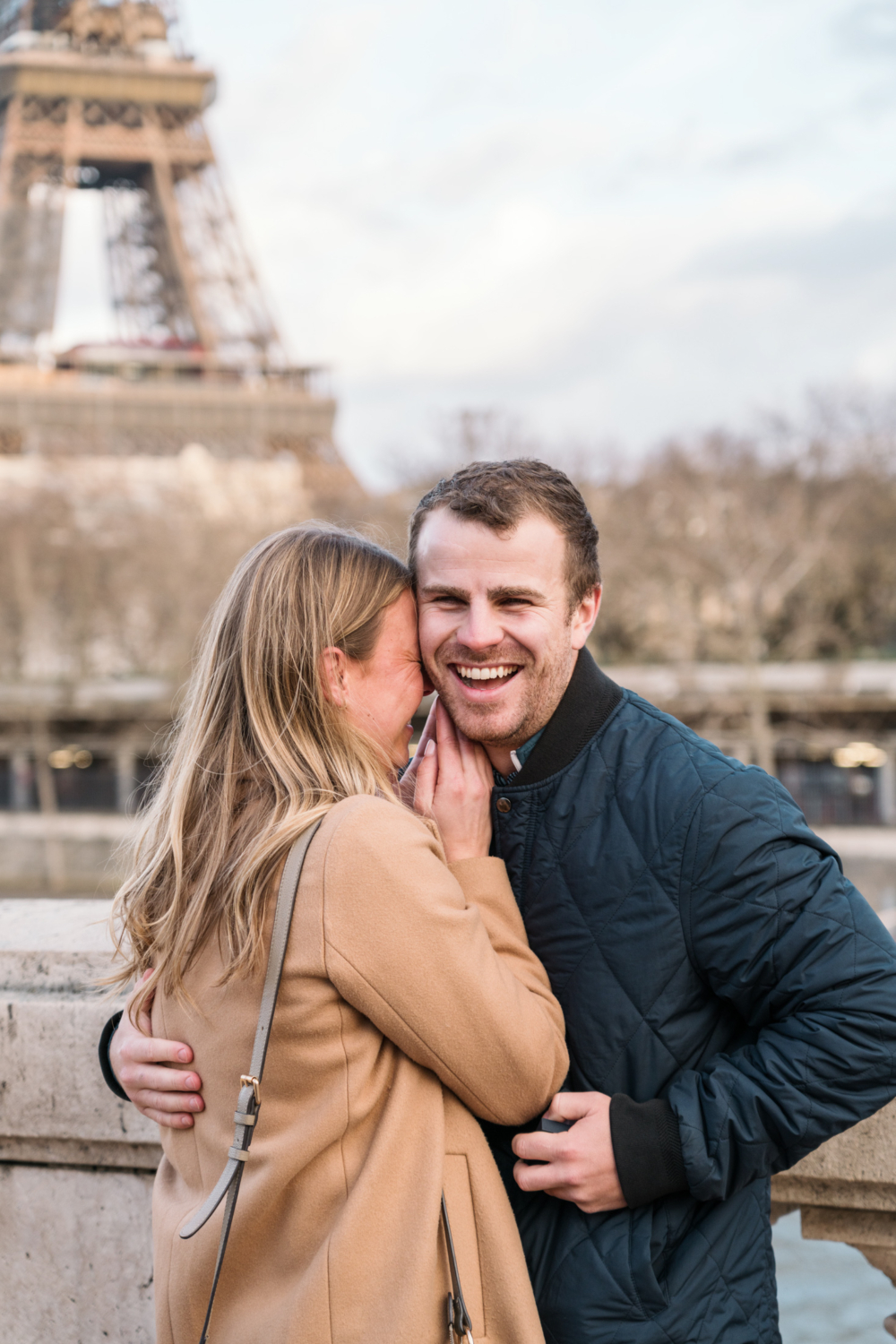 man smiles and laughs after presenting engagement ring in paris