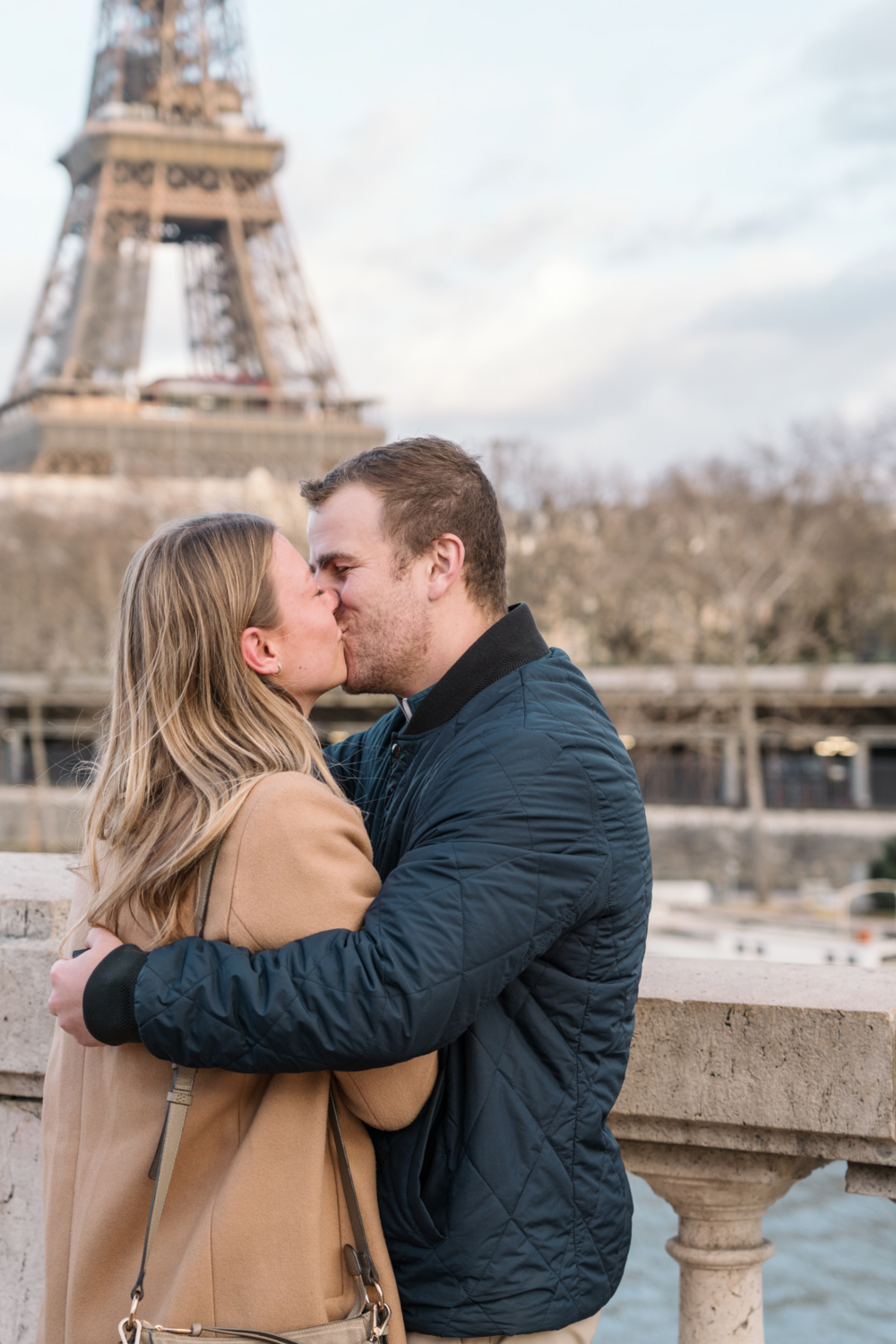 newly engaged couple kiss passionately in paris