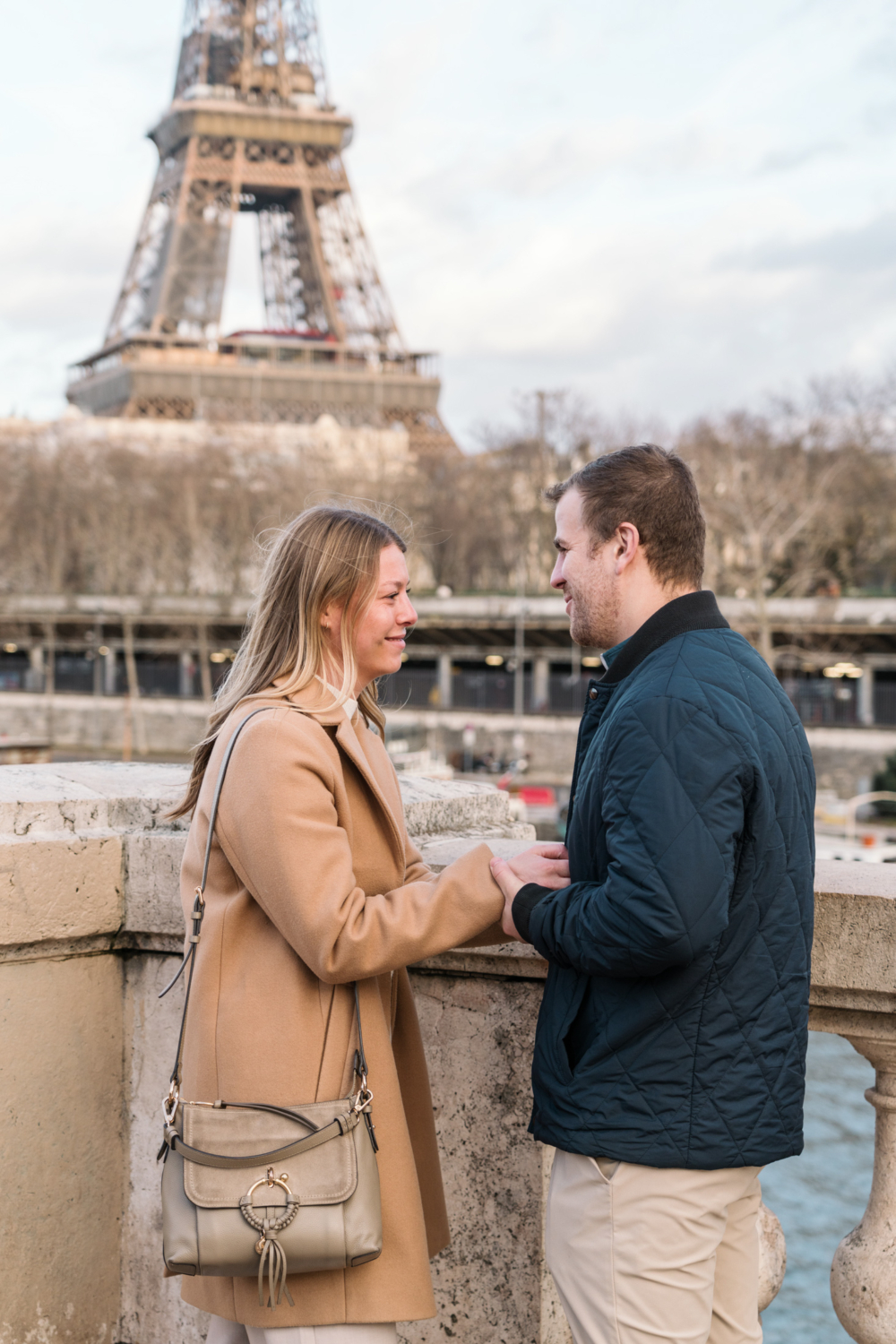 woman cries after man proposes with view of eiffel tower in paris