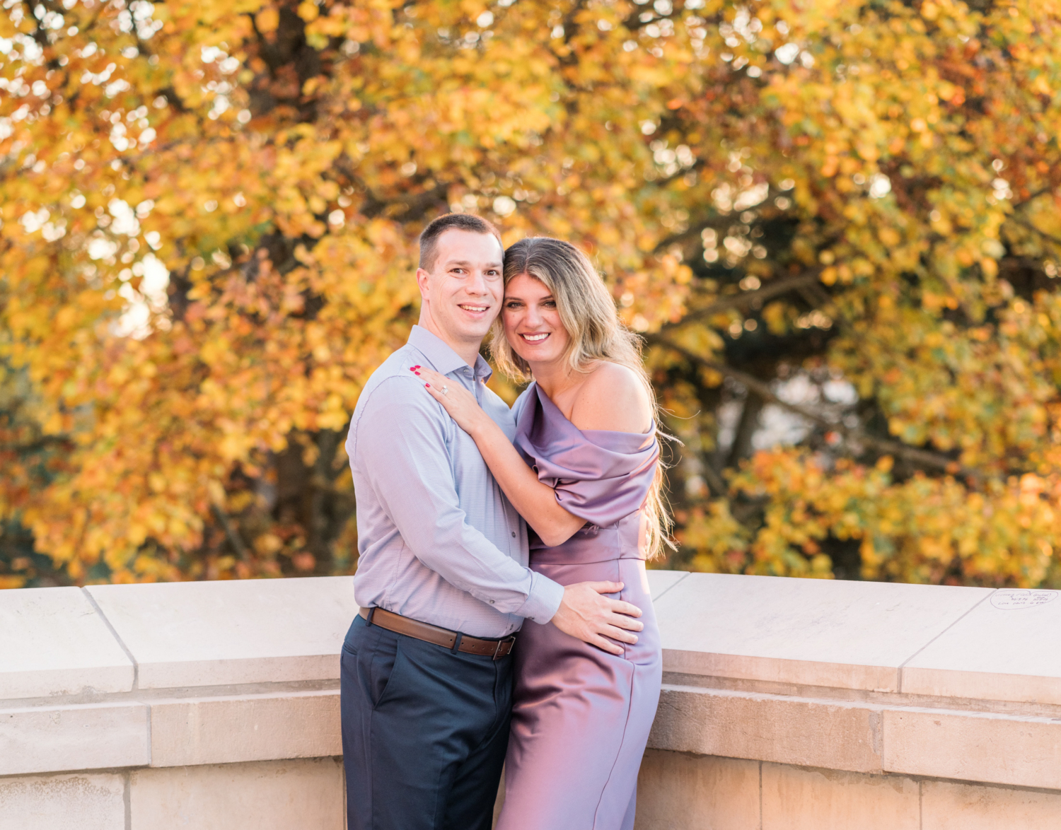 couple celebrate anniversary in paris with fall leaves behind them