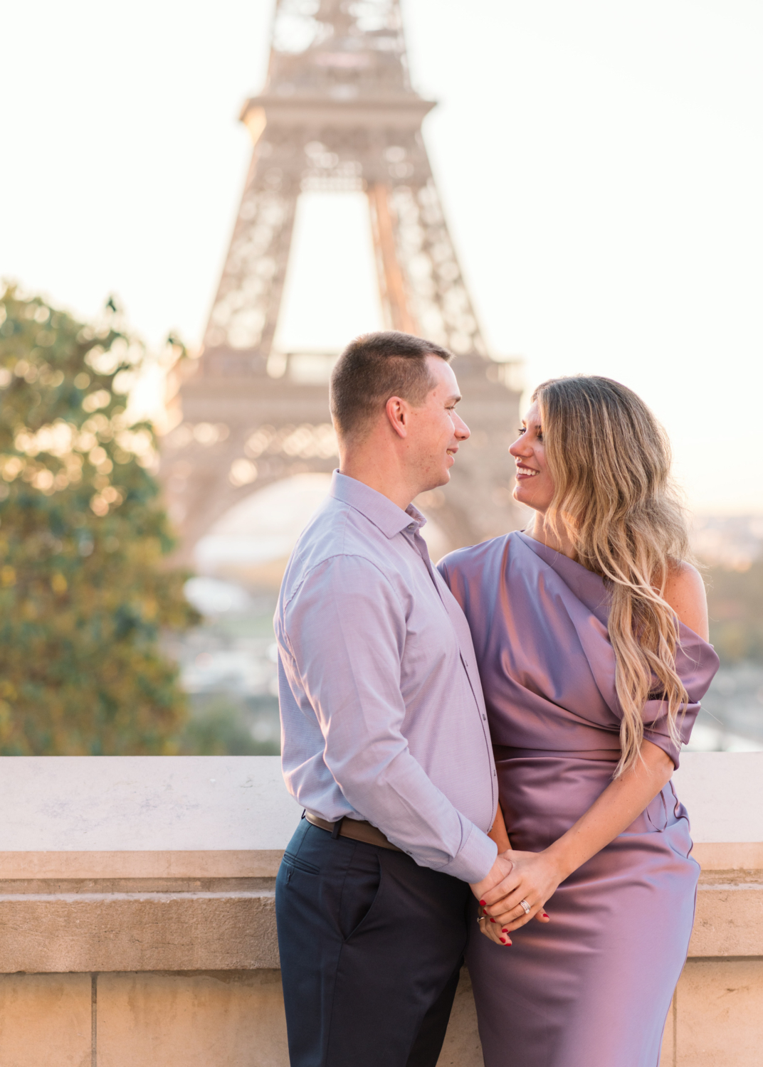 adorable couple pose with view of eiffel tower in paris