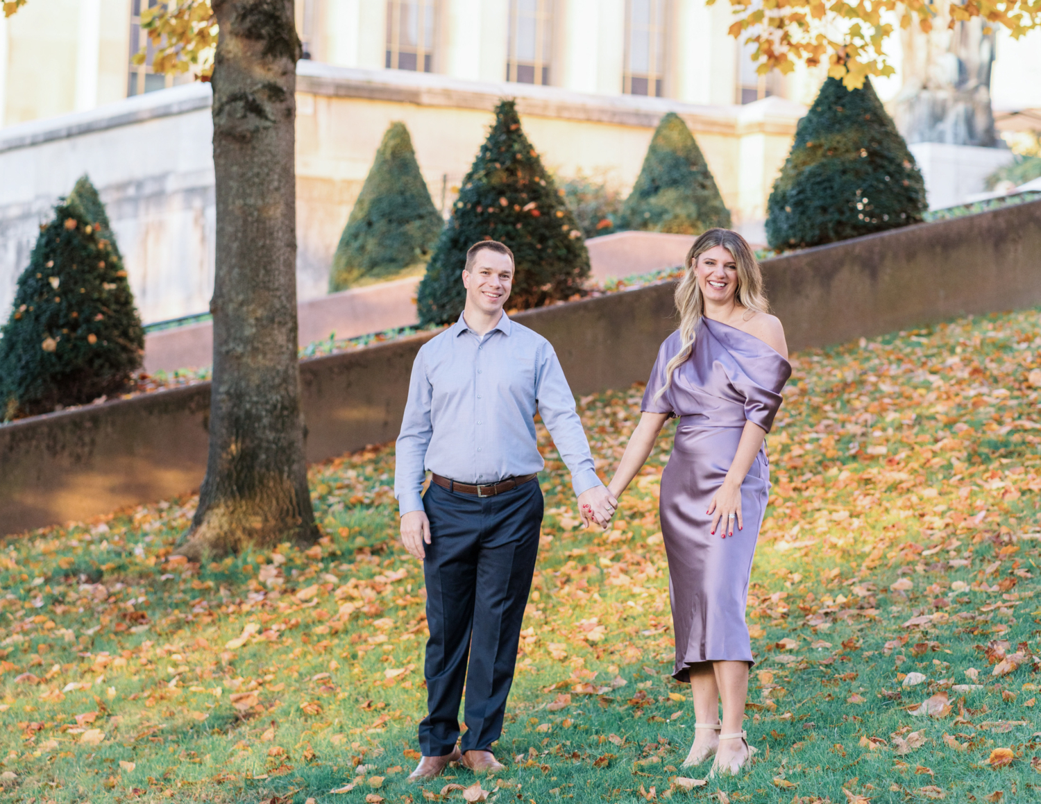 beautiful married couple pose in paris with autumn leaves