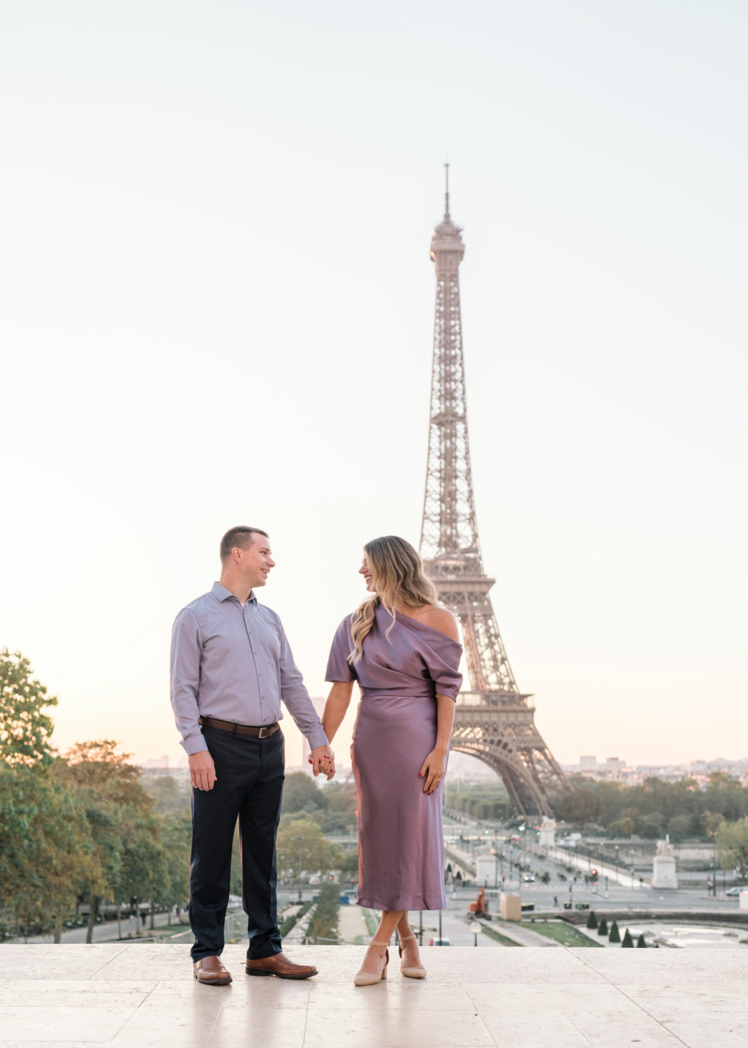 stunning couple pose side by side in paris with eiffel tower view