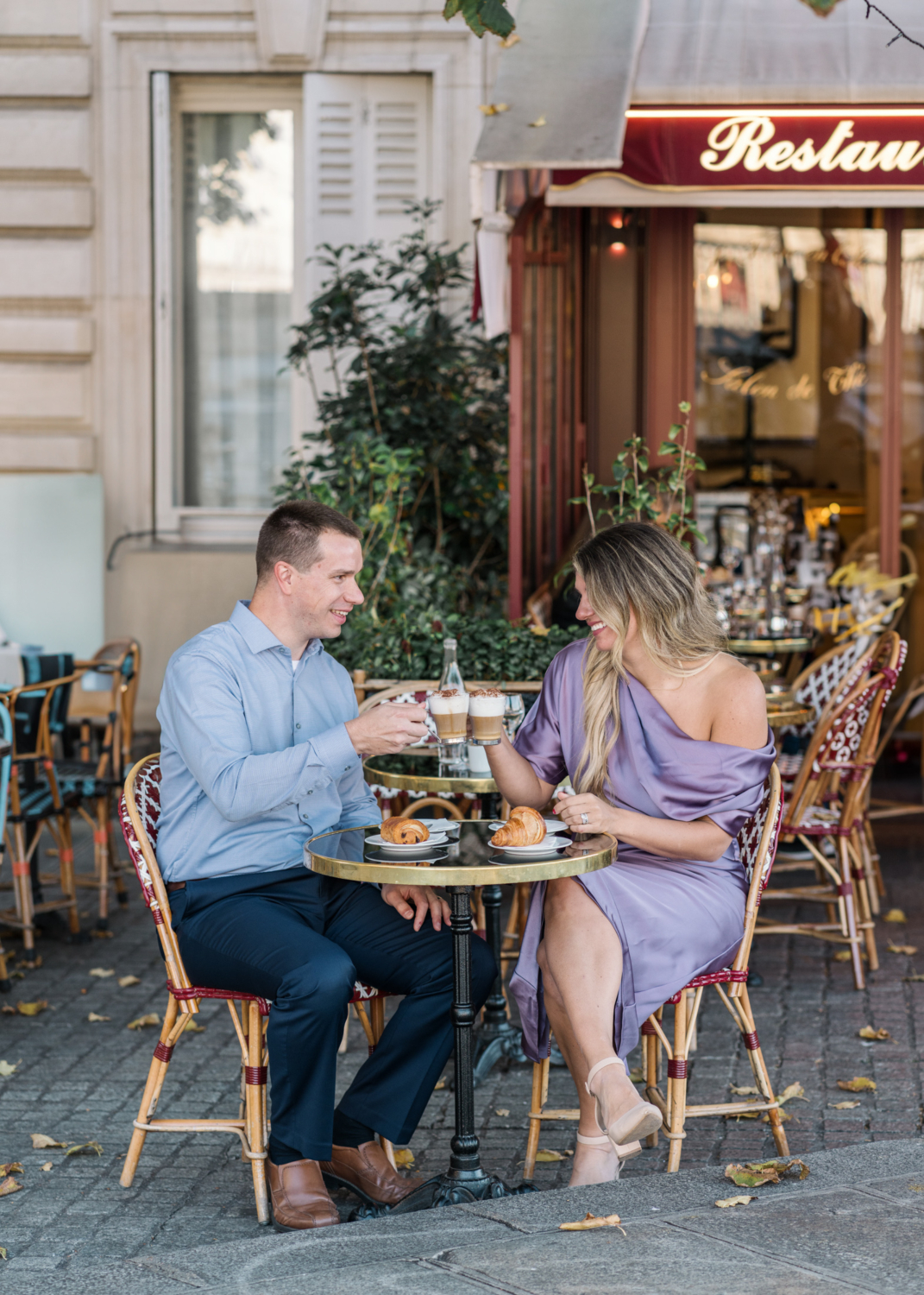 cute couple make cappucino toast to their anniversary at charming paris cafe