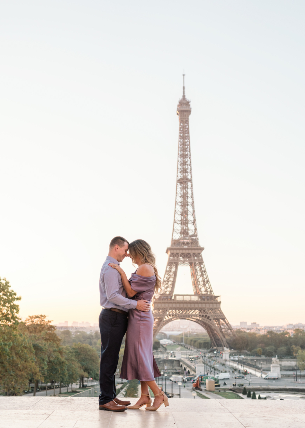 beautiful married couple pose at sunrise in paris with eiffel tower view