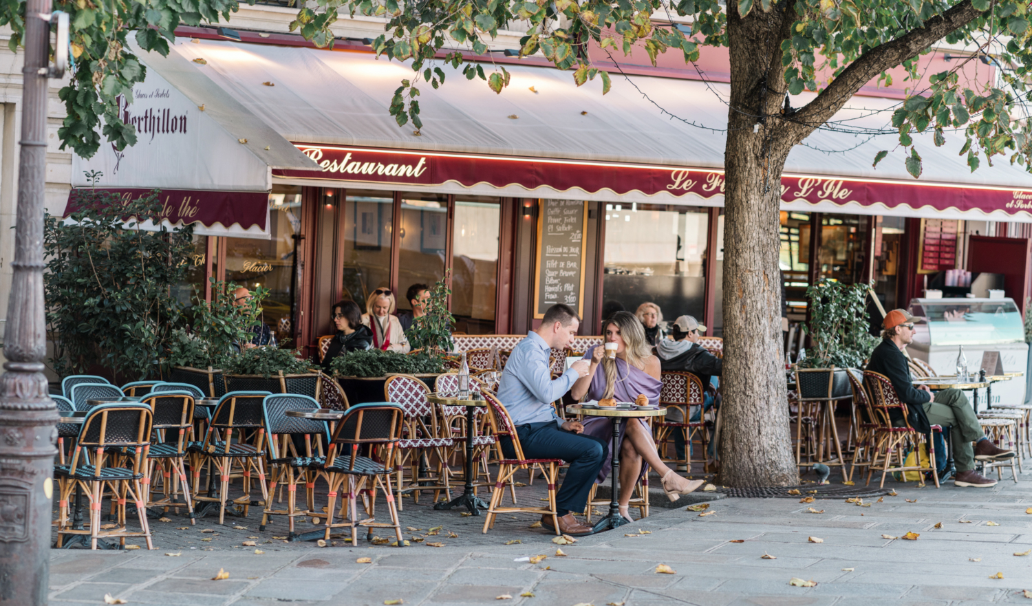 married couple enjoy coffee at cafe in paris