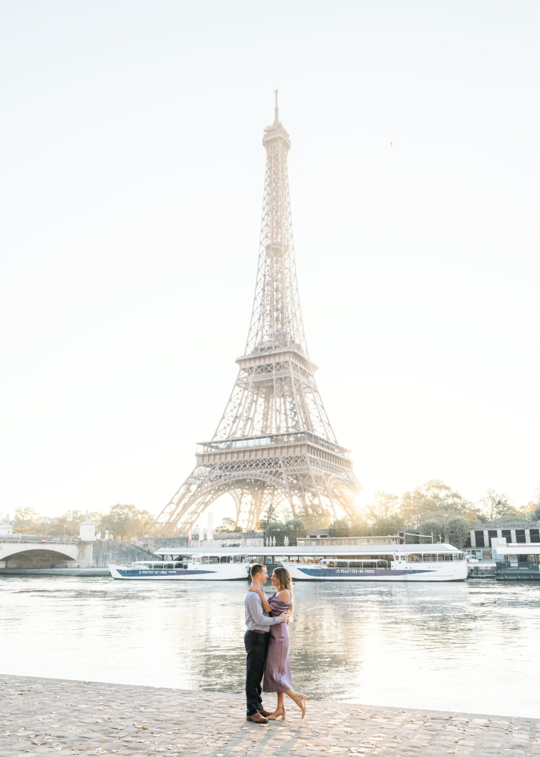 beautiful couple embrace with sunrise view of the eiffel tower in paris