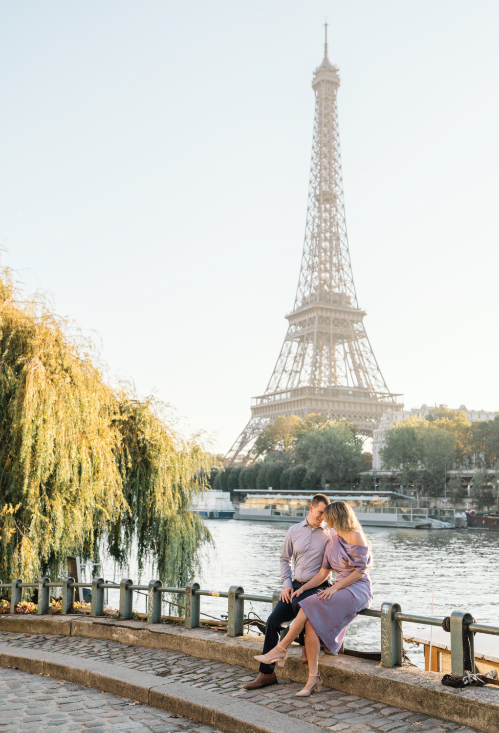 couple in love pose with stunning view of the eiffel tower