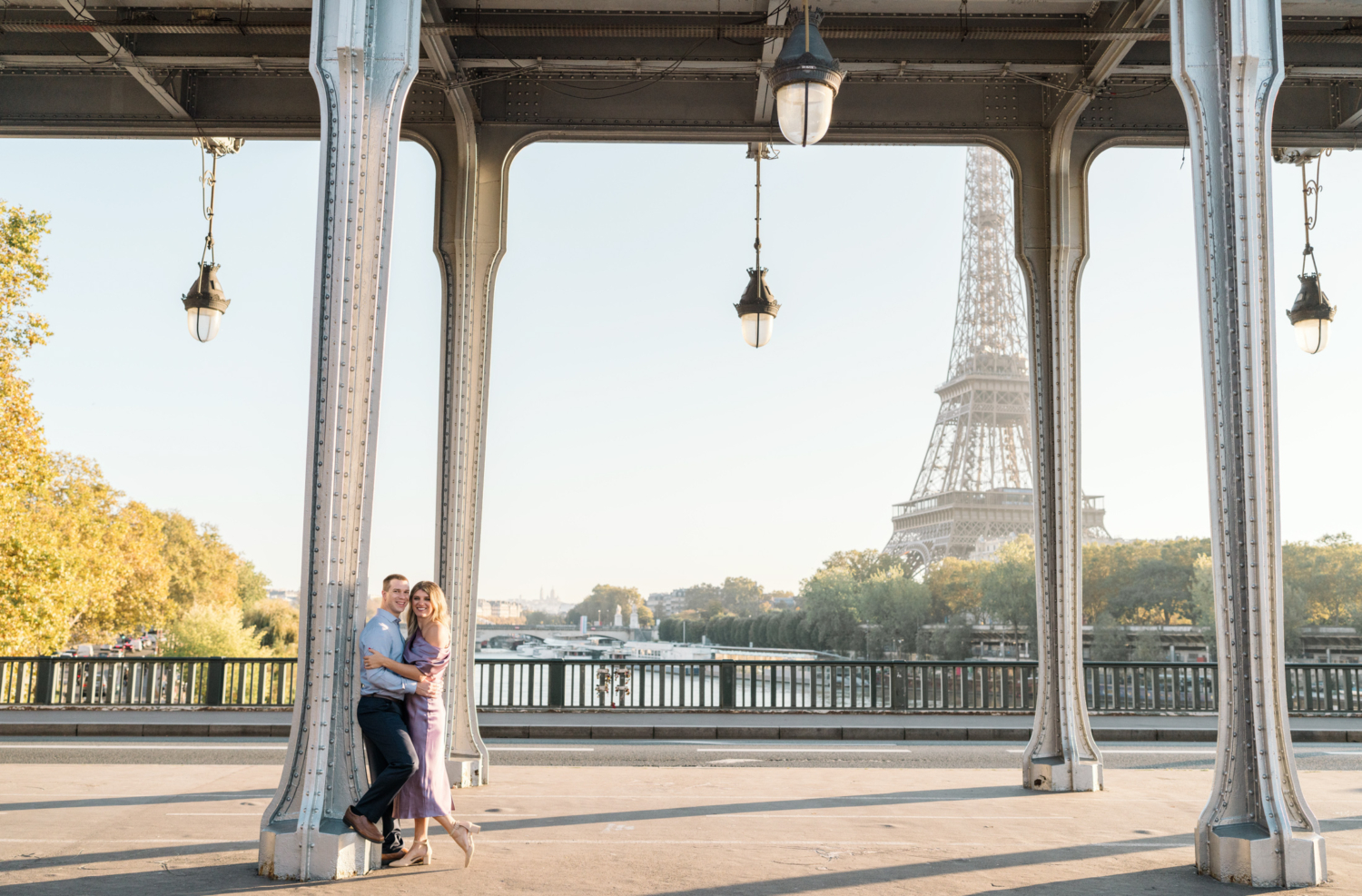 cute couple pose with view of eiffel tower in background in paris