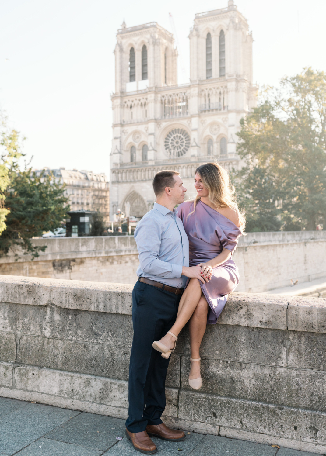 cute married couple pose outside of notre dame cathedral in paris