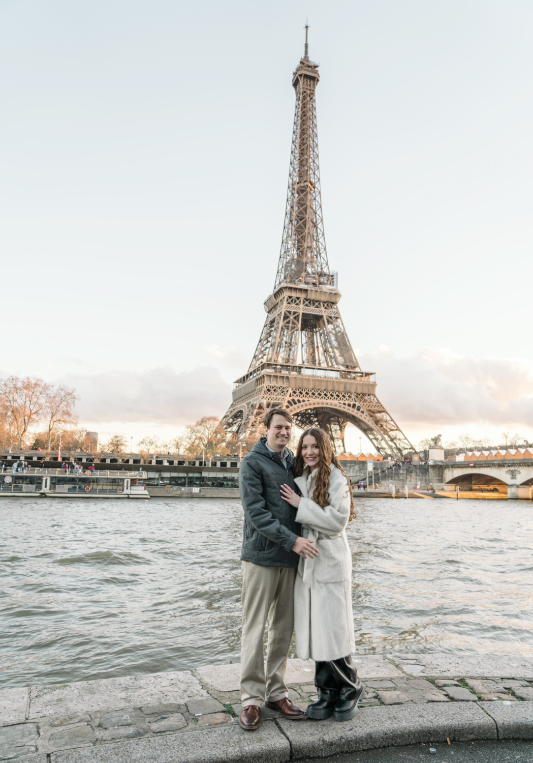 newly engaged couple pose with view of the eiffel tower in paris