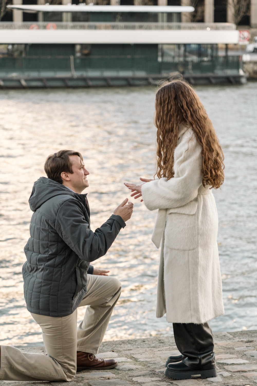 man presents diamond engagement ring in paris france