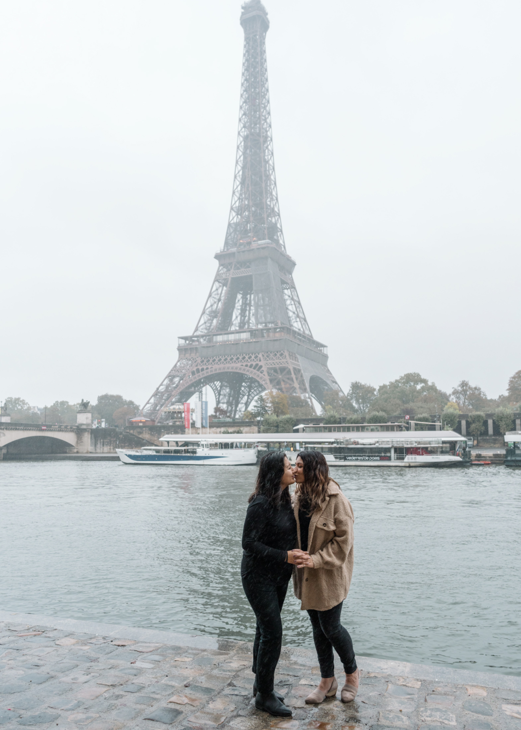 two women kiss after their engagement in paris france in front of eiffel tower