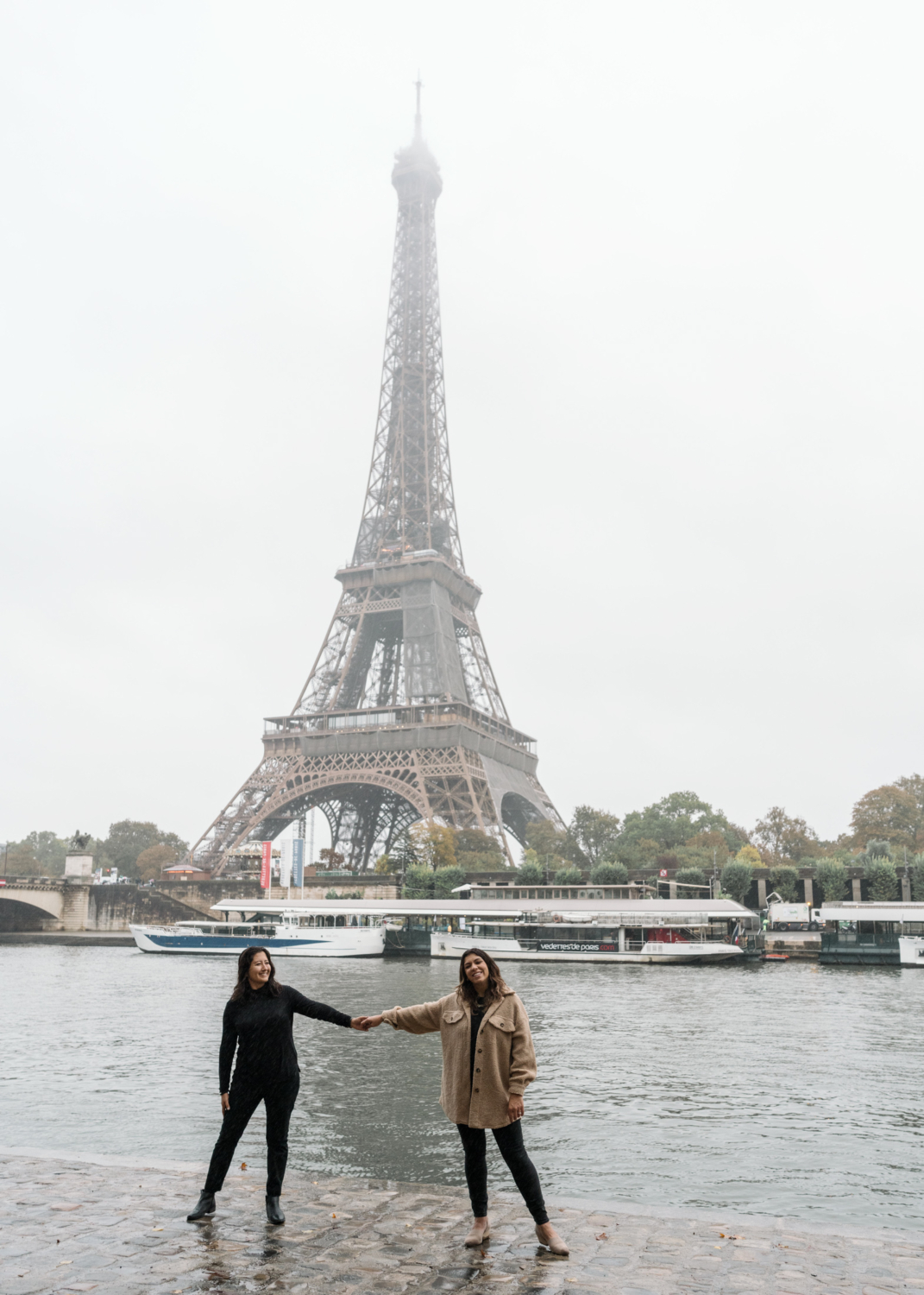 two women pose after their engagement in paris france