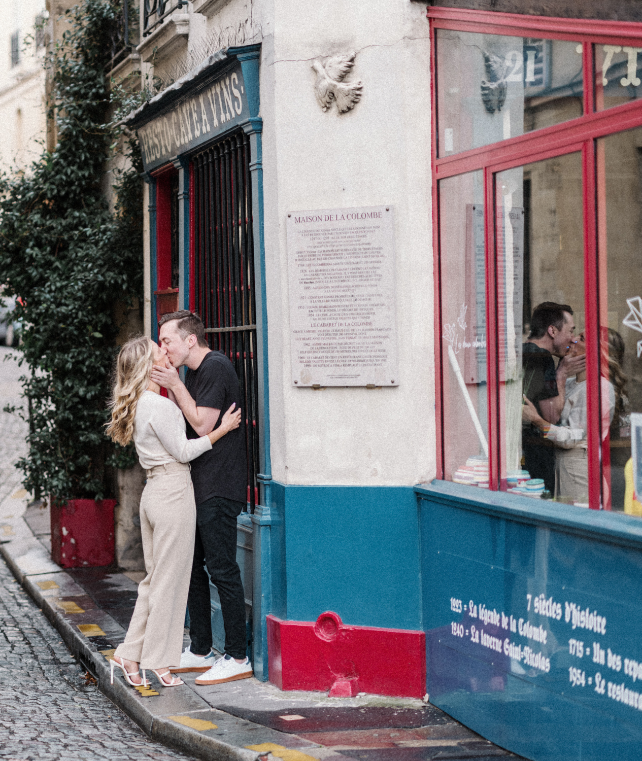 cute young newly engaged couple kiss passionately during their engagement photoshoot in paris